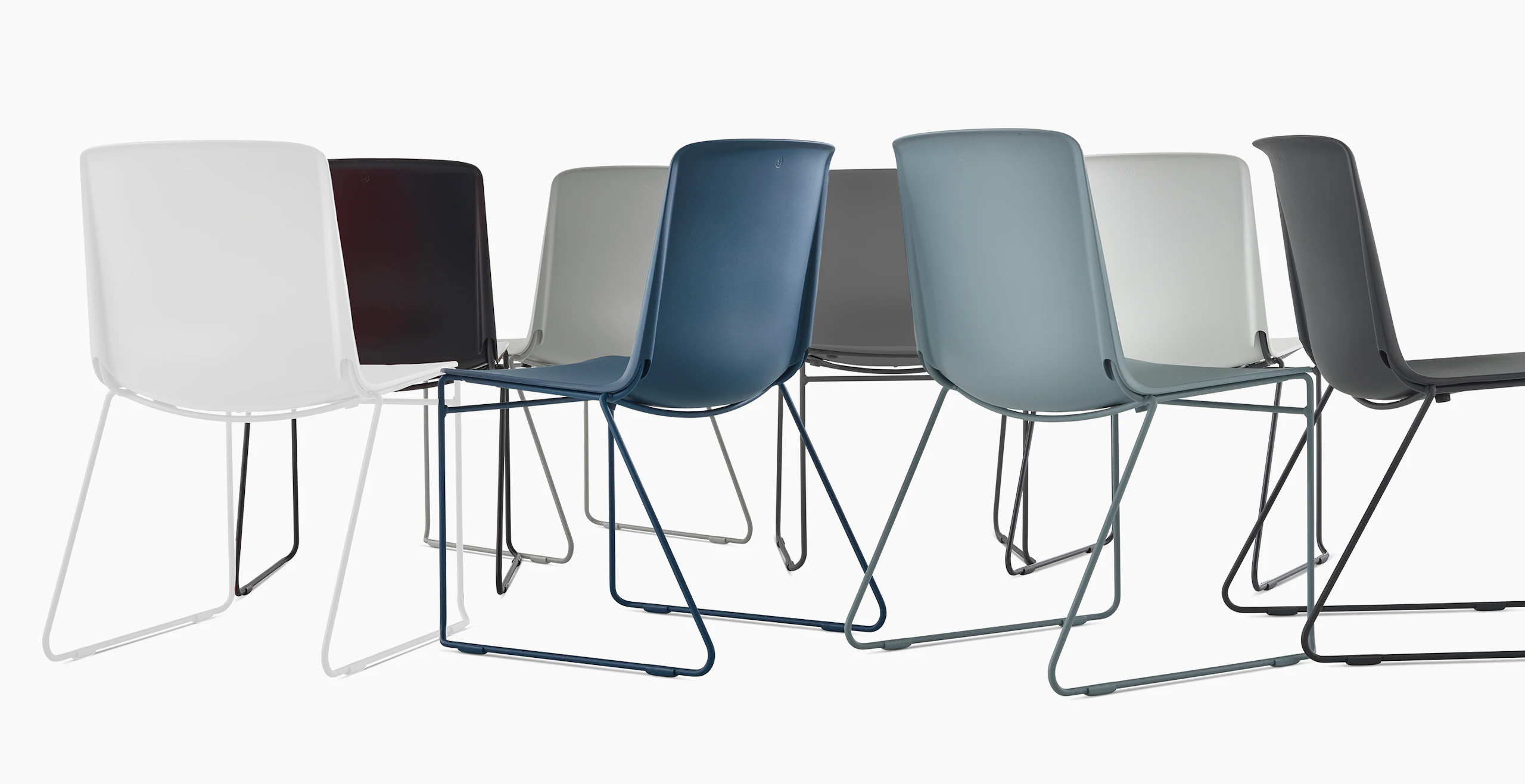 A group of multi colored Pronta Stacking Chairs.