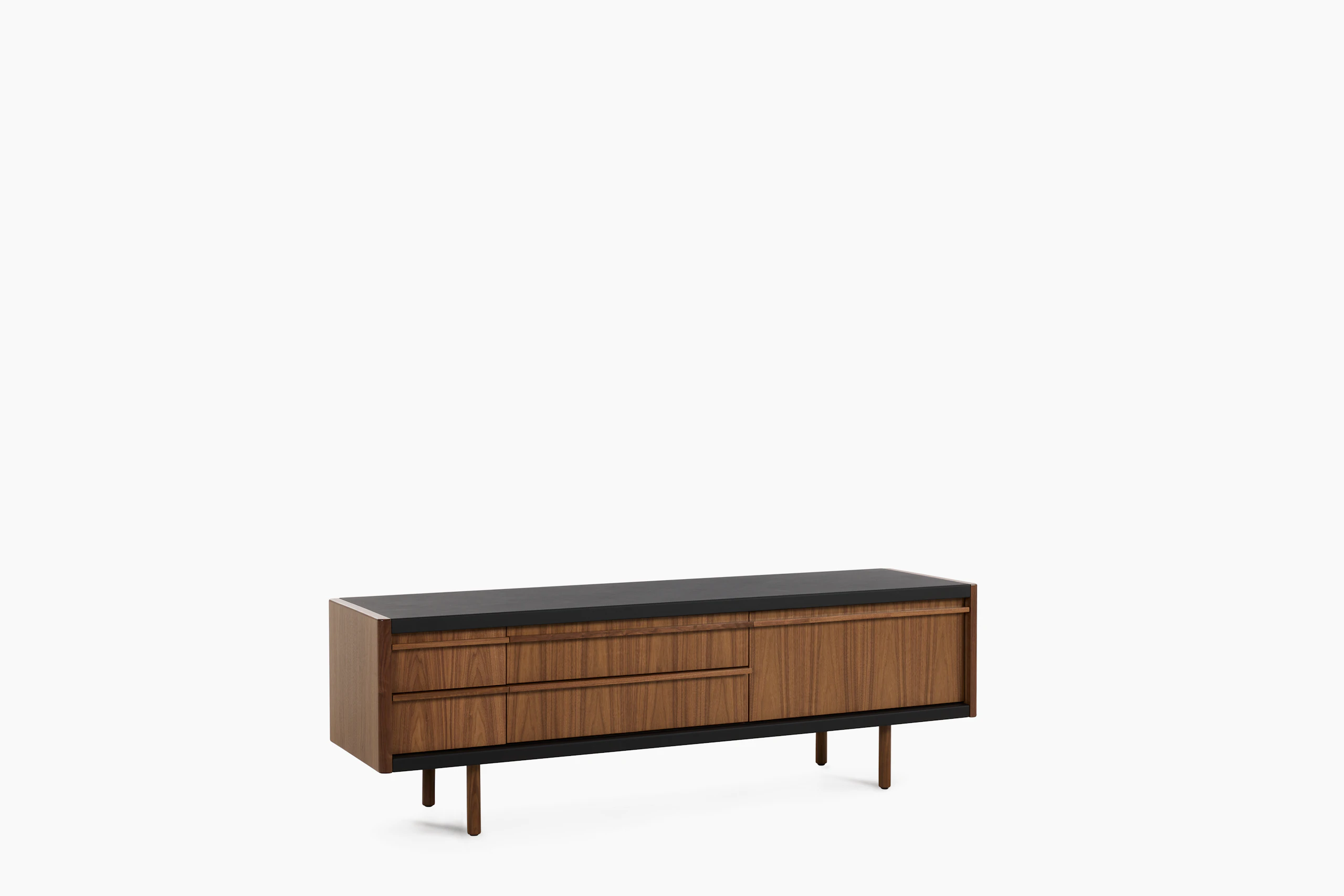 New Canaan Media Unit designed by BassamFellows for Geiger in Walnut with Black Leather shown angled on a white sweep.