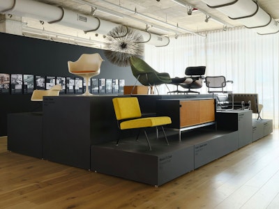 Iconic furniture from the MillerKnoll Collective, such as a green Knoll Womb Chair, and Eames Lounge Chair and Ottoman, and an Eames Molded Plastic chair, on display at the MillerKnoll Design Days