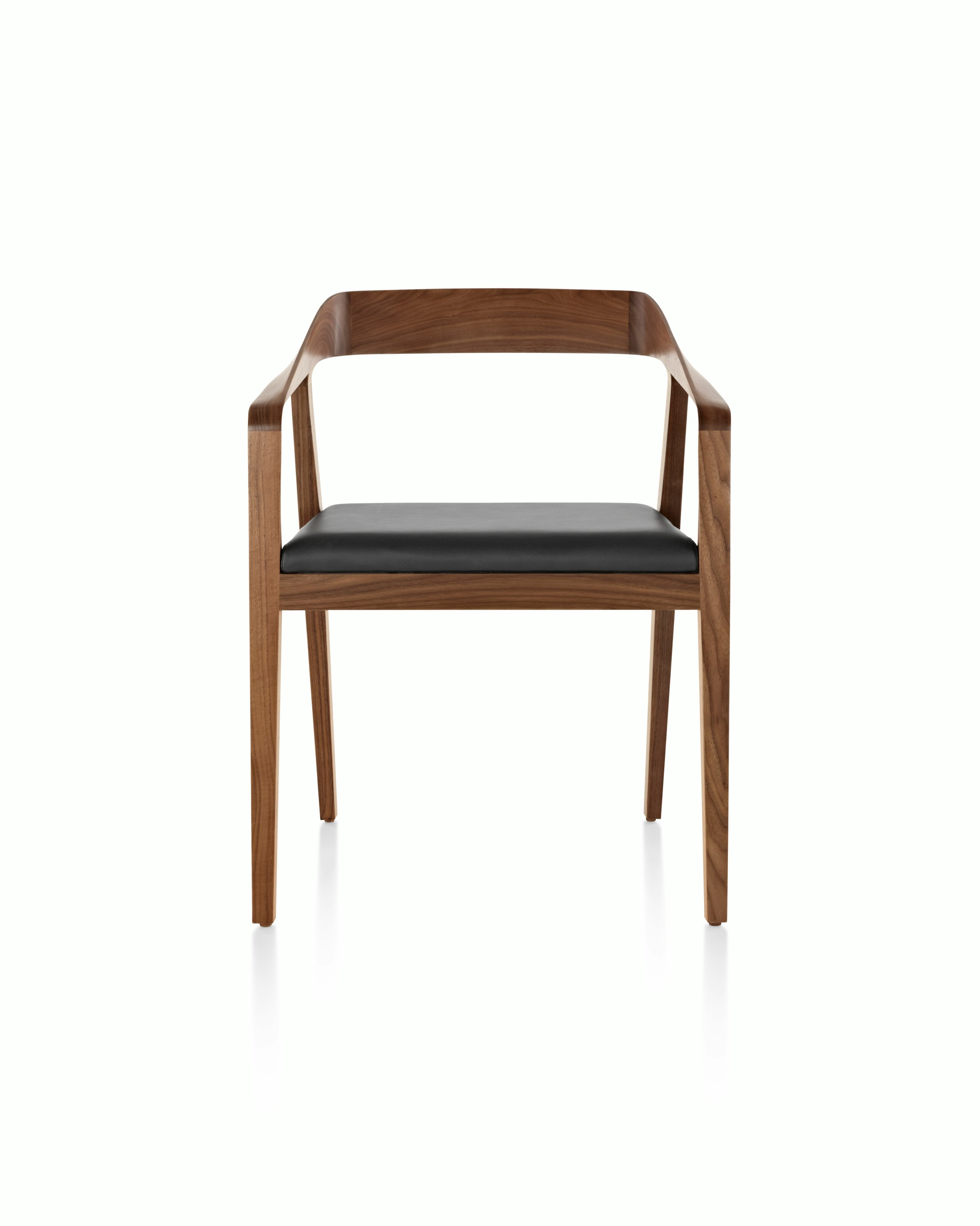 A Full Twist Guest Chair with a black leather seat pad and a wood frame in a medium finish, viewed from the front.