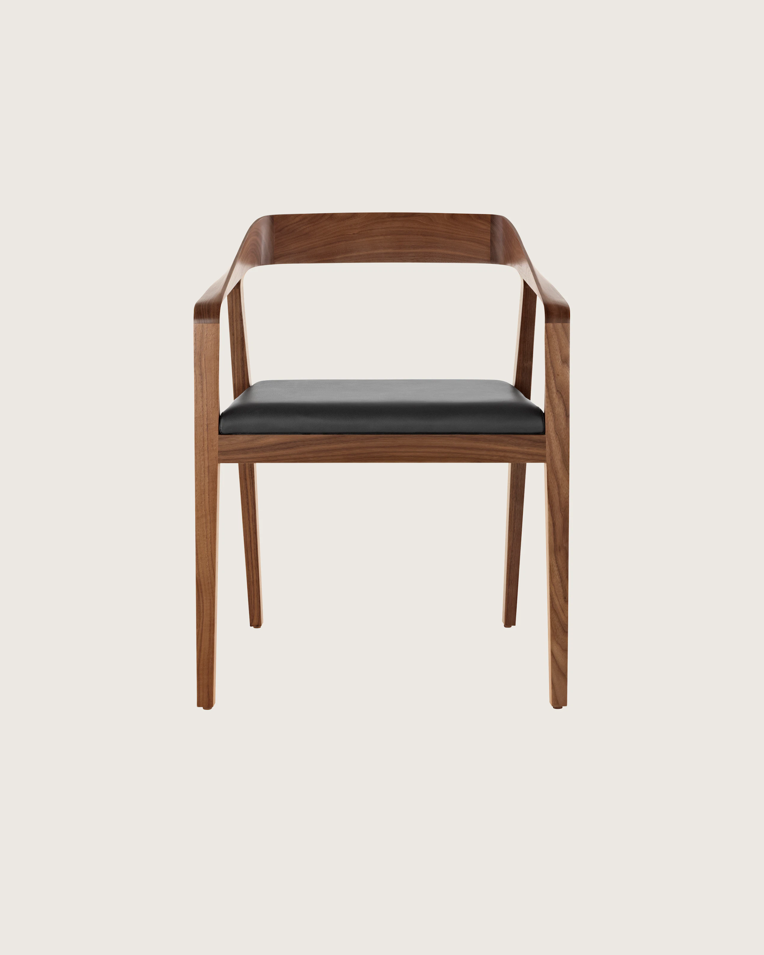 A Full Twist Guest Chair with a black leather seat pad and a wood frame in a medium finish, viewed from the front.