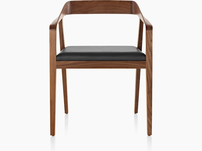 A Full Twist Guest Chair with a black leather seat pad and a wood frame in a medium finish, viewed from the front.