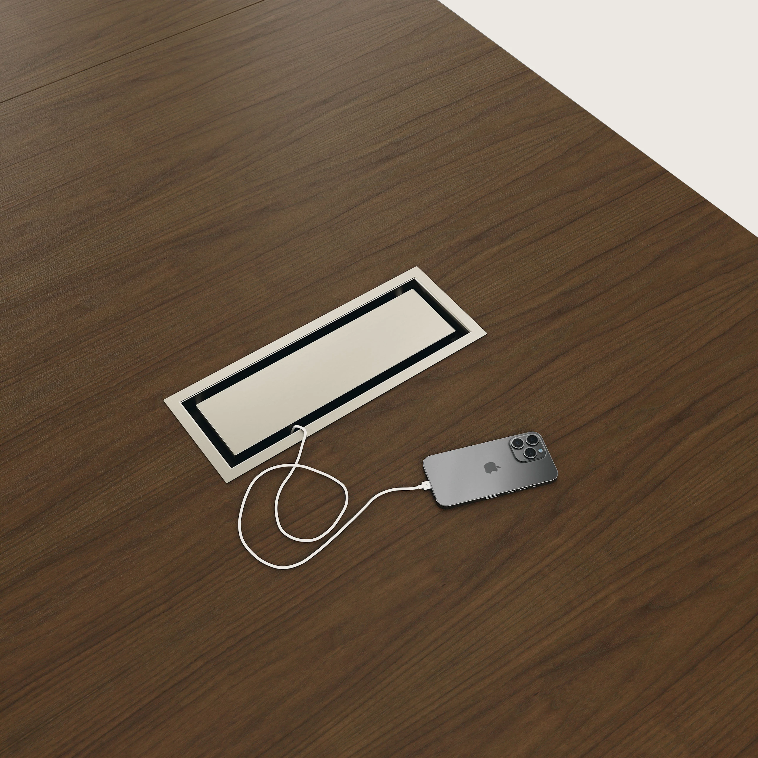 Detail shot of closed tabletop power access Highline Conference Table in Cashmere Flat Cut Walnut with Satin Nickel details.