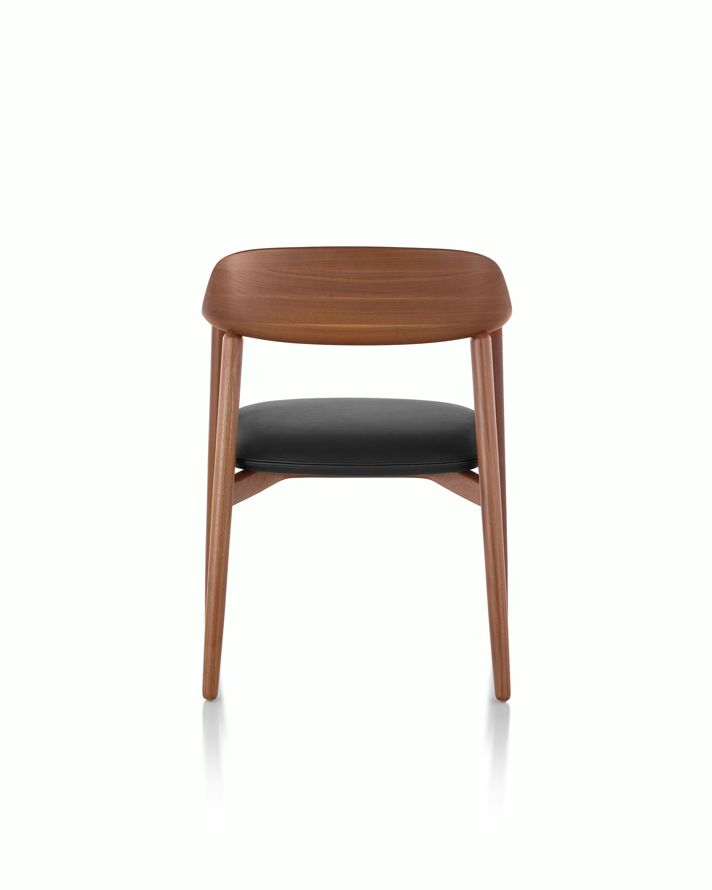 Close-up of the curved wood backrest on a Crosshatch Side Chair, viewed from behind.