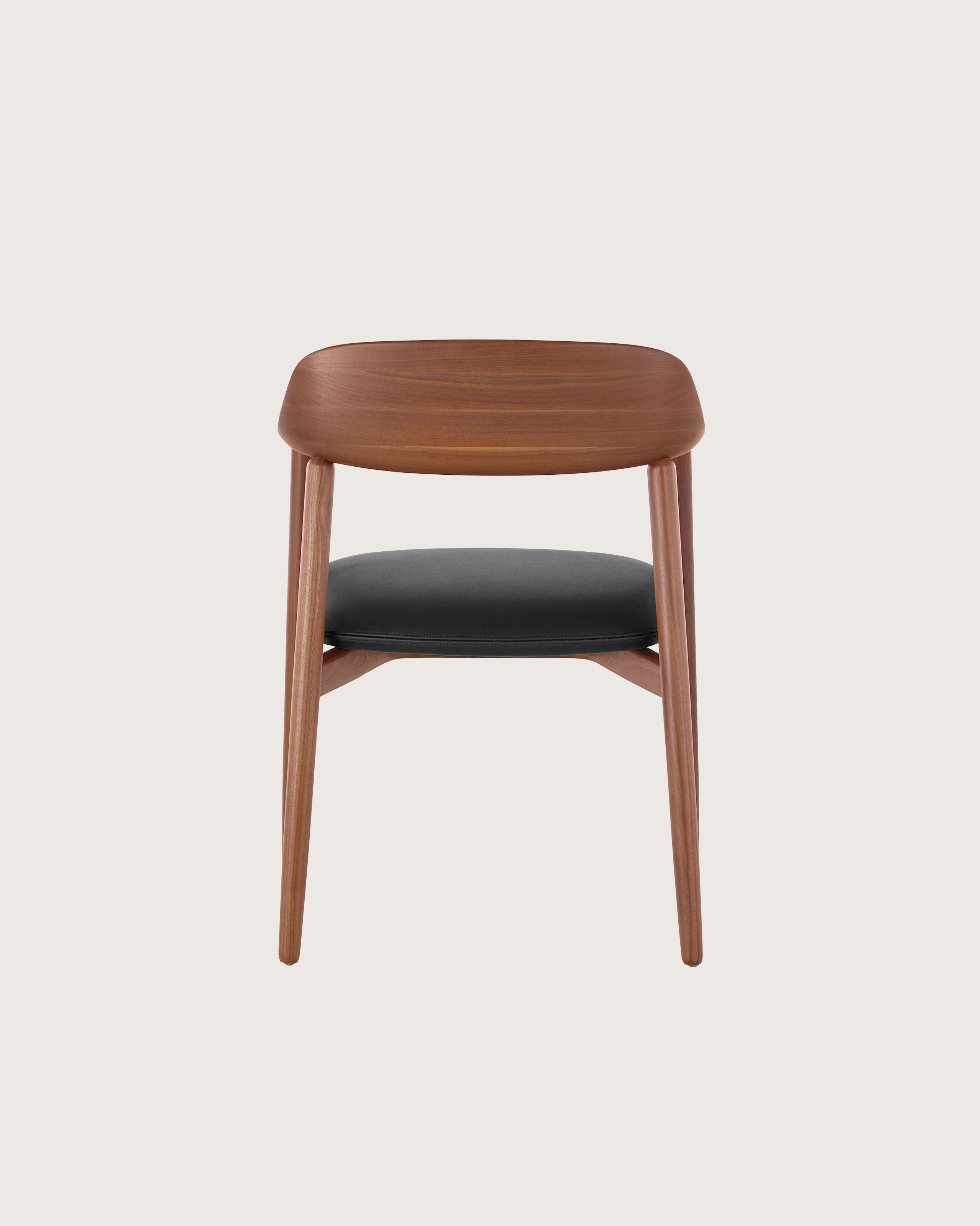 Close-up of the curved wood backrest on a Crosshatch Side Chair, viewed from behind.