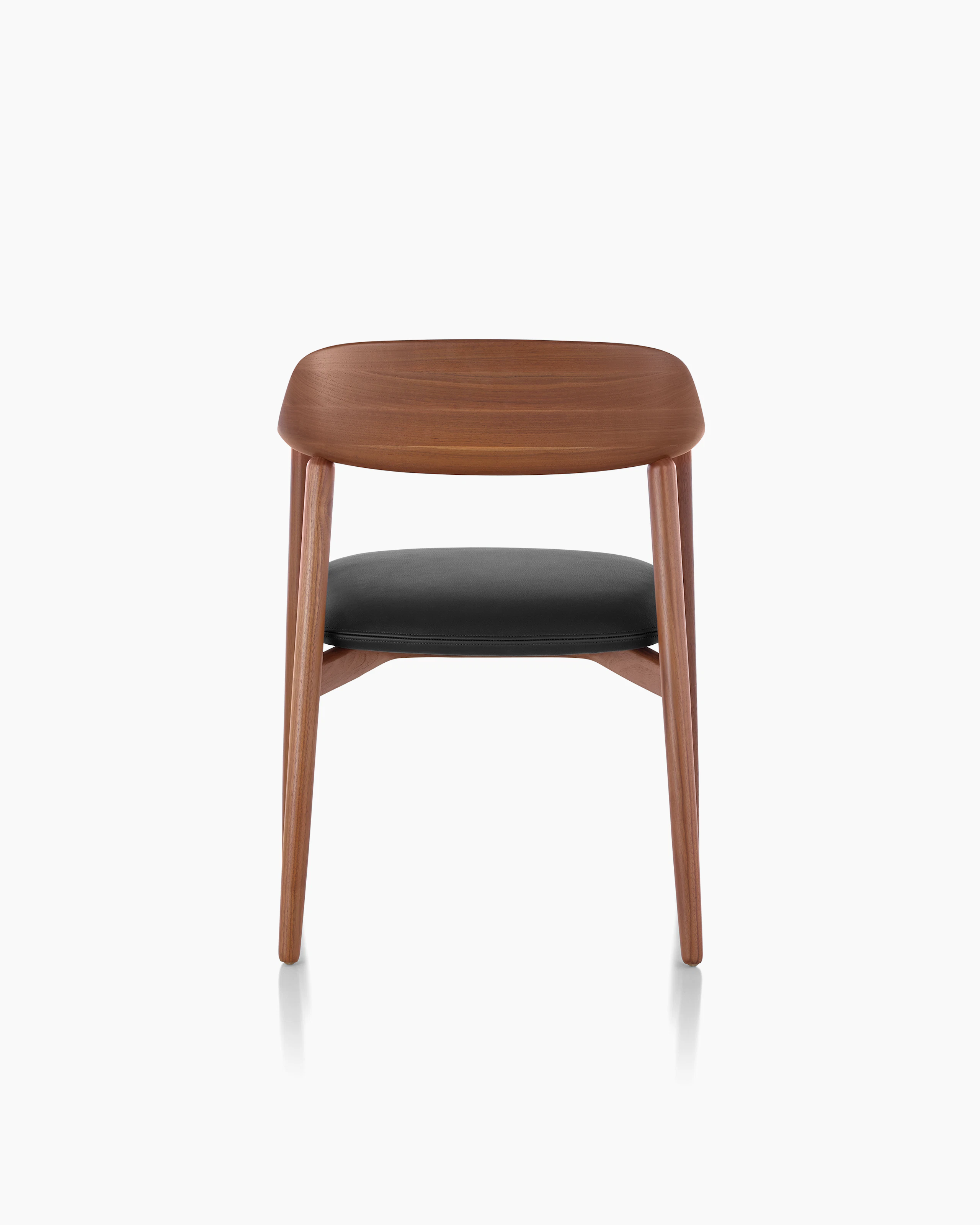 Close-up of the curved wood backrest on a Crosshatch Side Chair, viewed from behind.