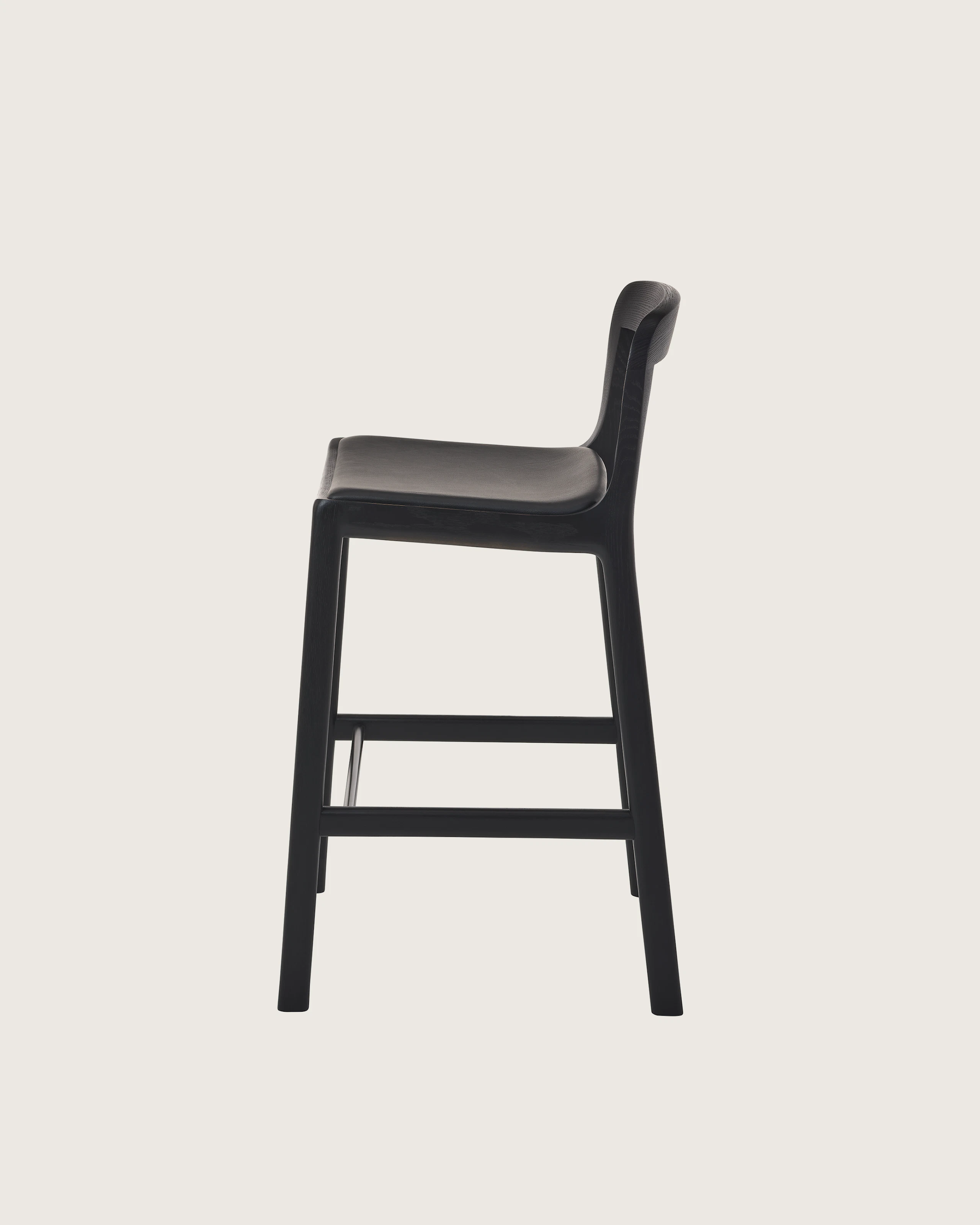 Lijn Stool by Carole Baijings for Geiger in Ebonized Oak frame upholstered with Maharam Prone Leather in Obsidian, side view on a white sweep.