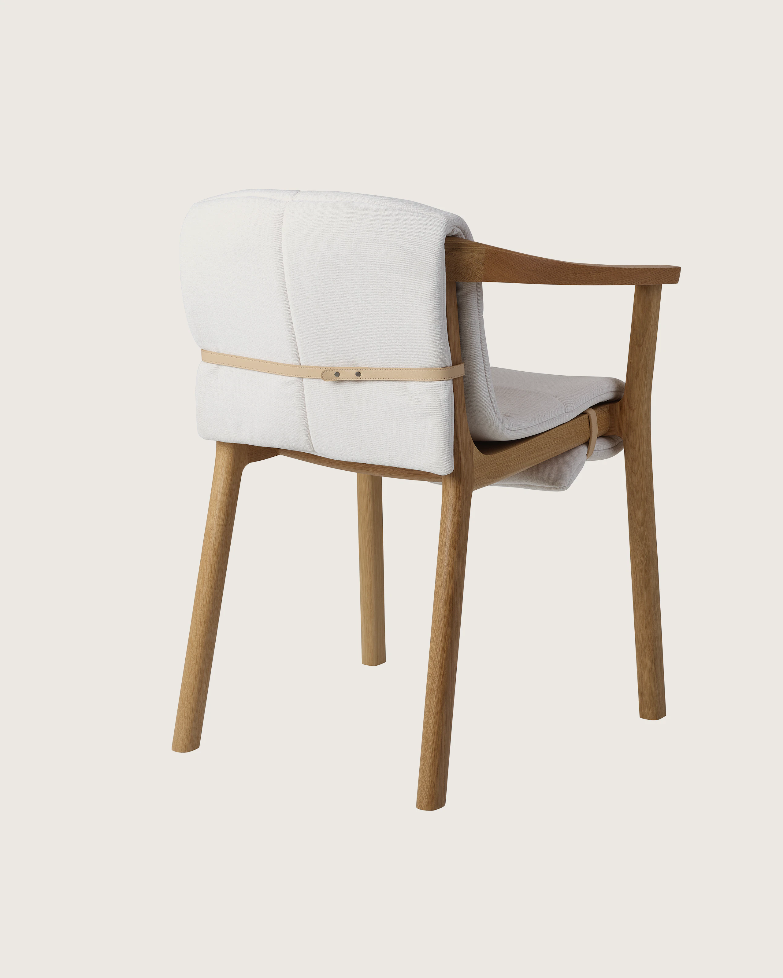 Lijn Armchair by Carole Baijings for Geiger in Natural Oak frame with quilted wrap in Vionette White Sand Mix, angled back view on a white sweep.