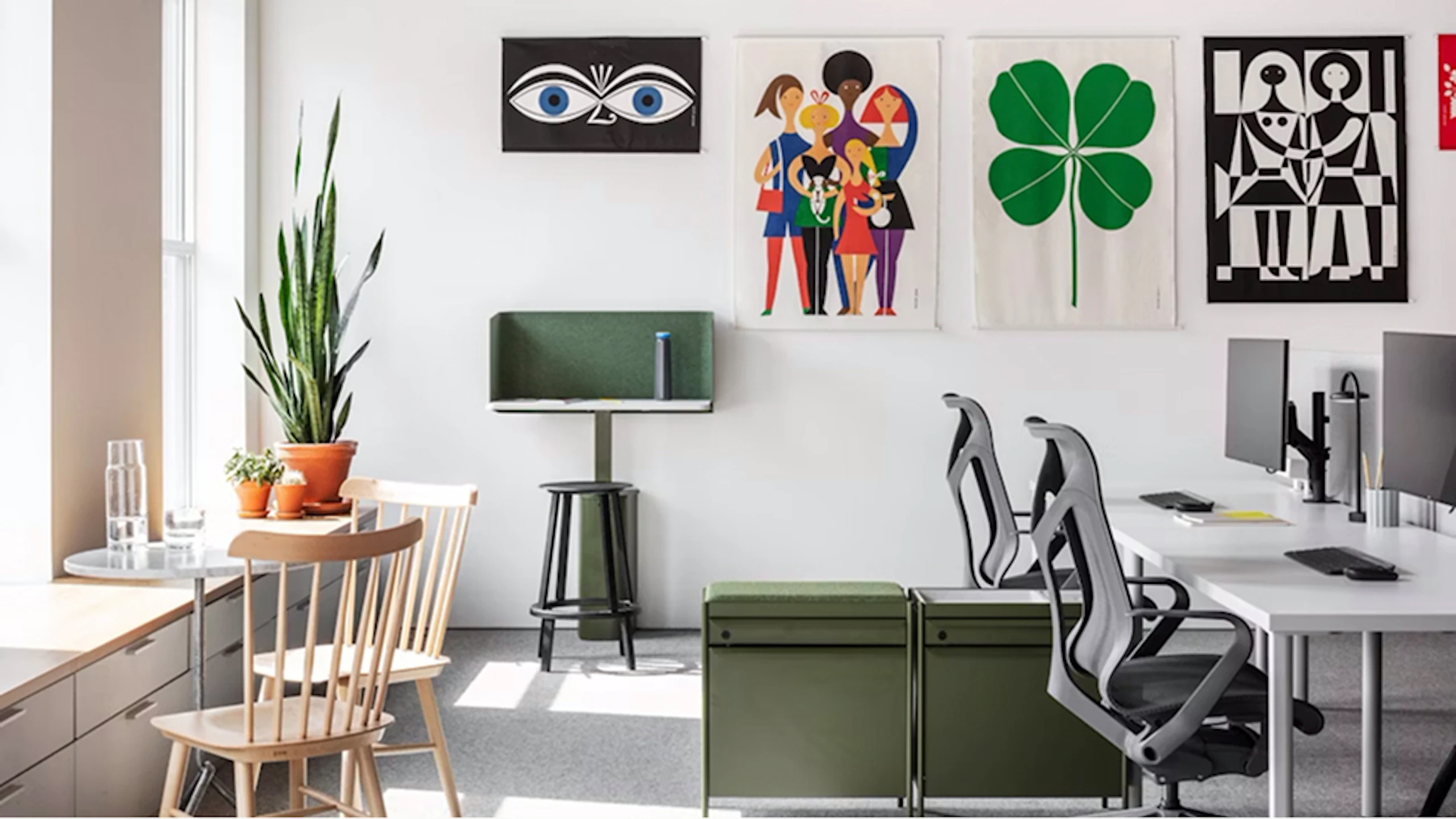 A sunlit office space featuring a variety of furniture from the MillerKnoll collective of brands such as Herman Miller Cosm Chairs, OE1 Storage Trolleys and OE1 workstations