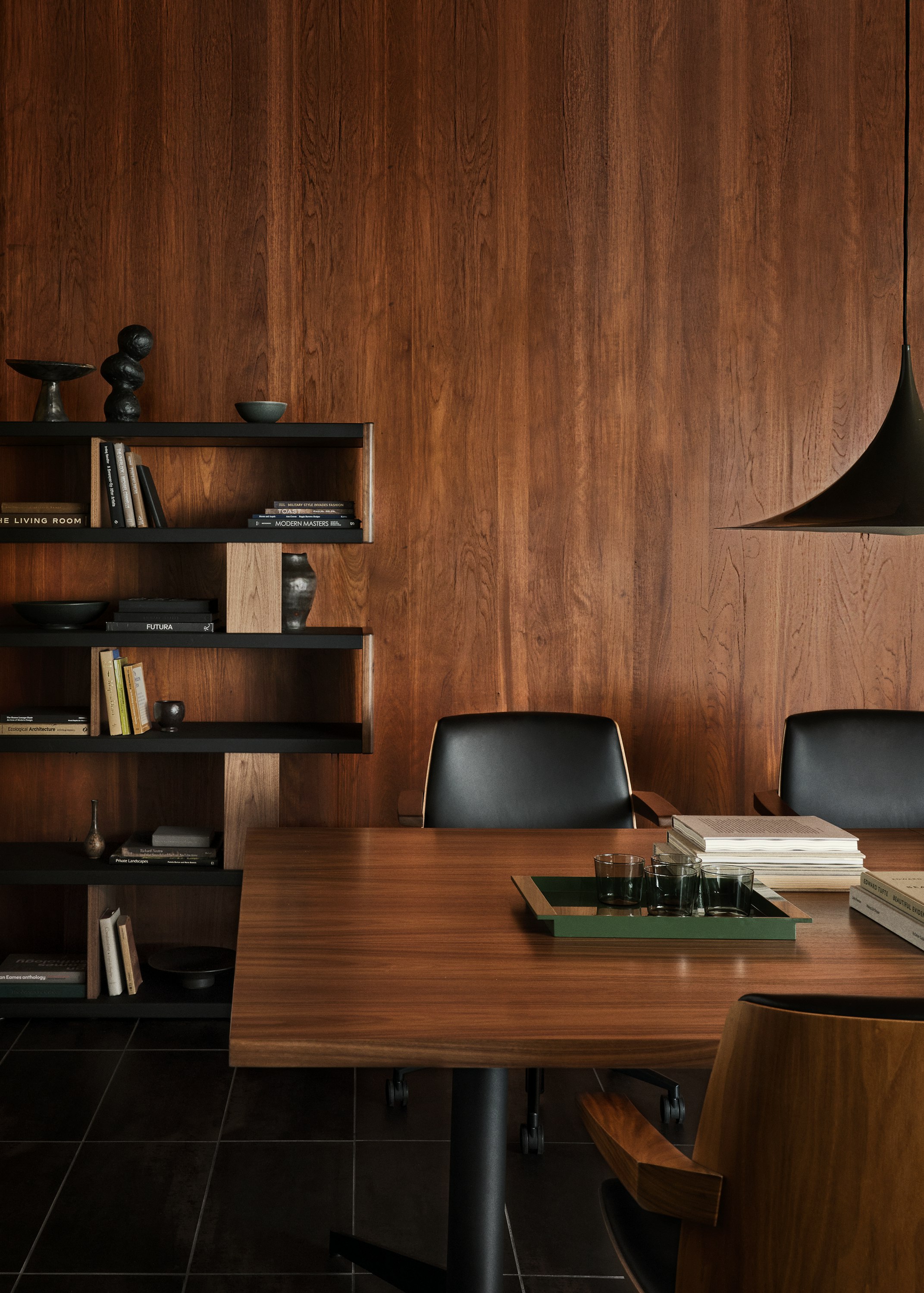MP Conference Table designed by Amir Paknya for Geiger in Natural Flat Cut Walnut shown with low-back Clamshell Chairs and a New Canaan Bookshelf.