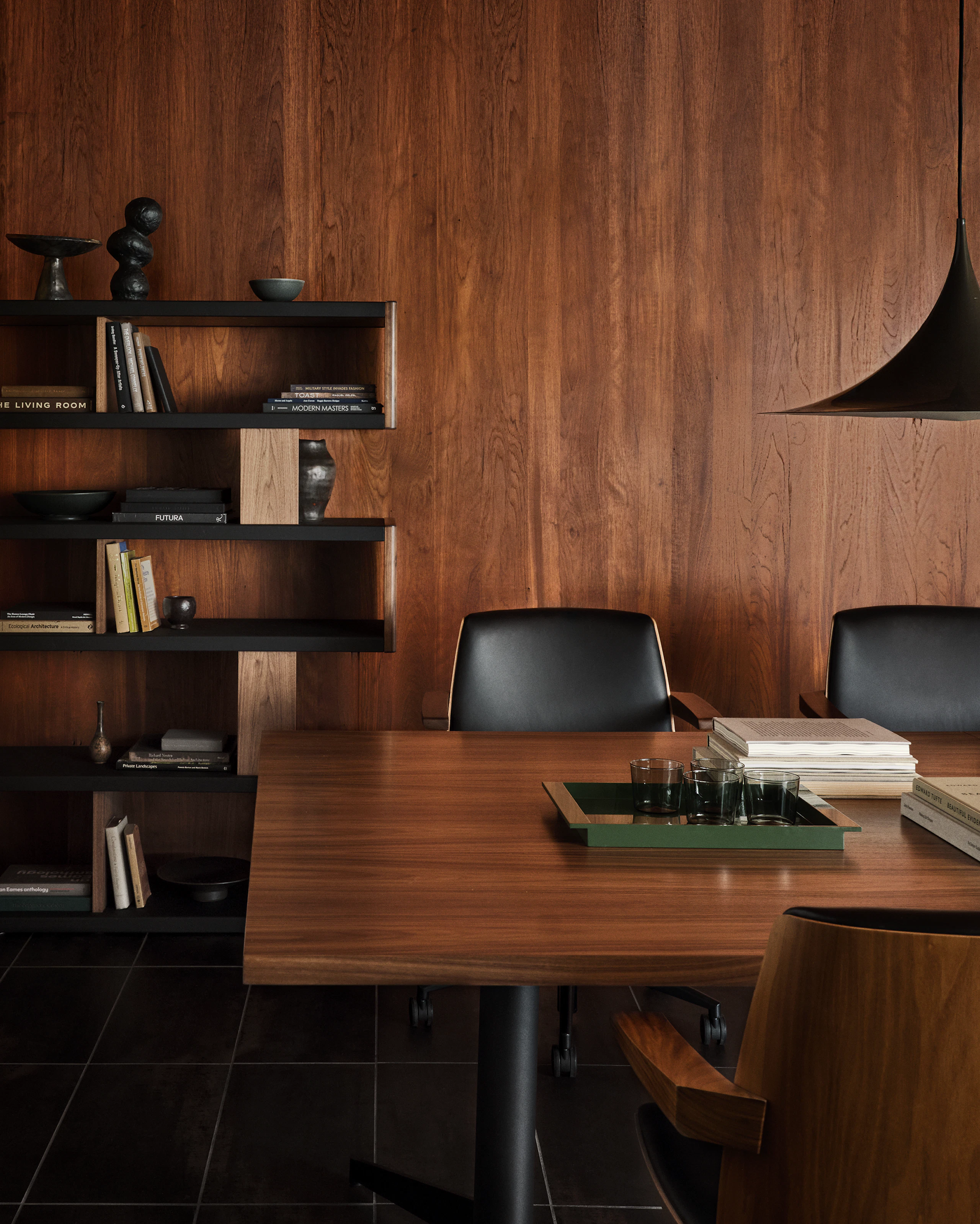 MP Conference Table designed by Amir Paknya for Geiger in Natural Flat Cut Walnut shown with low-back Clamshell Chairs and a New Canaan Bookshelf.
