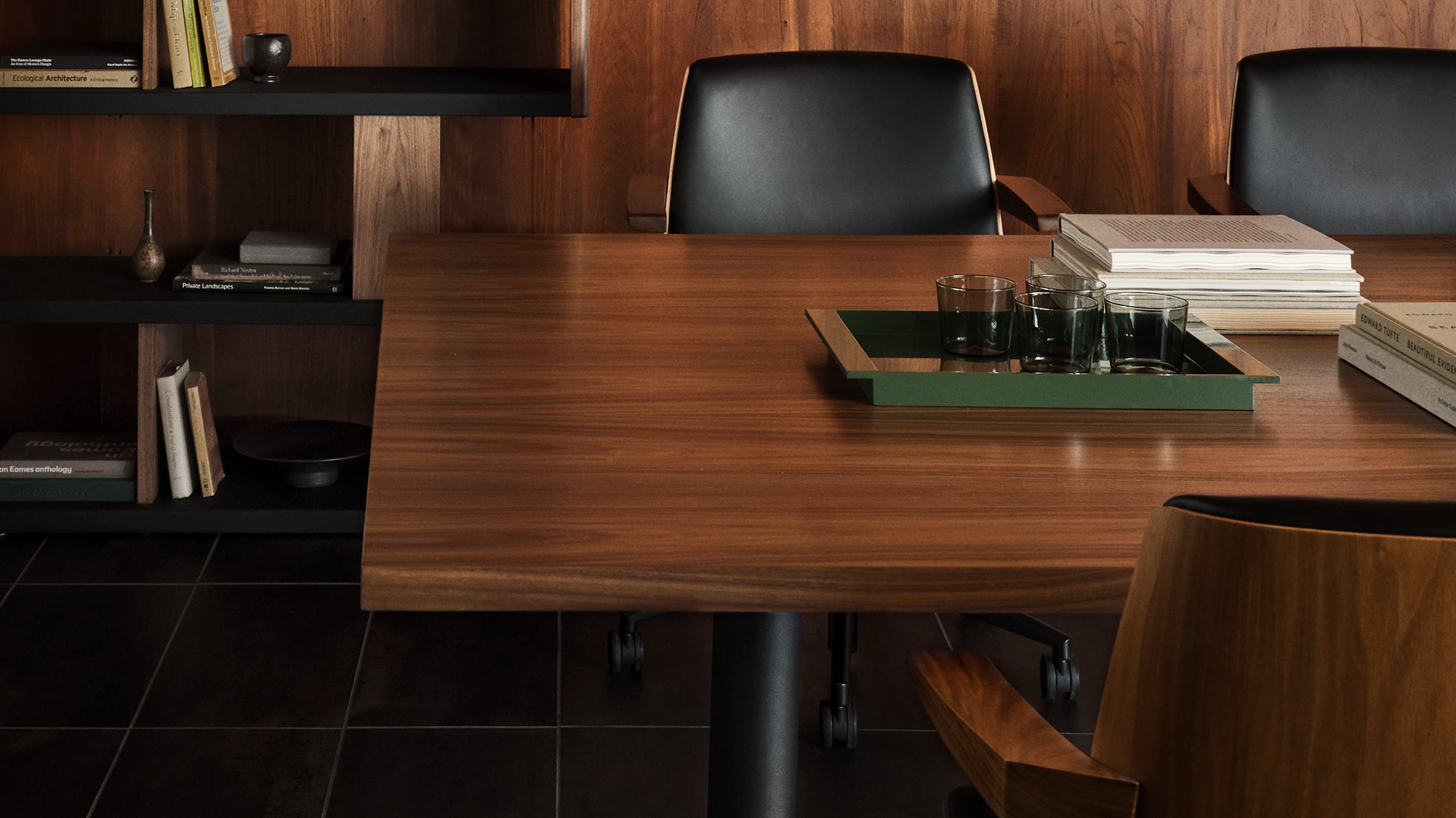 MP Table designed by Amir Paknya for Geiger in Natural Flat Cut Walnut shown with Low-Back Clamshell Chairs and a New Canaan Bookshelf.