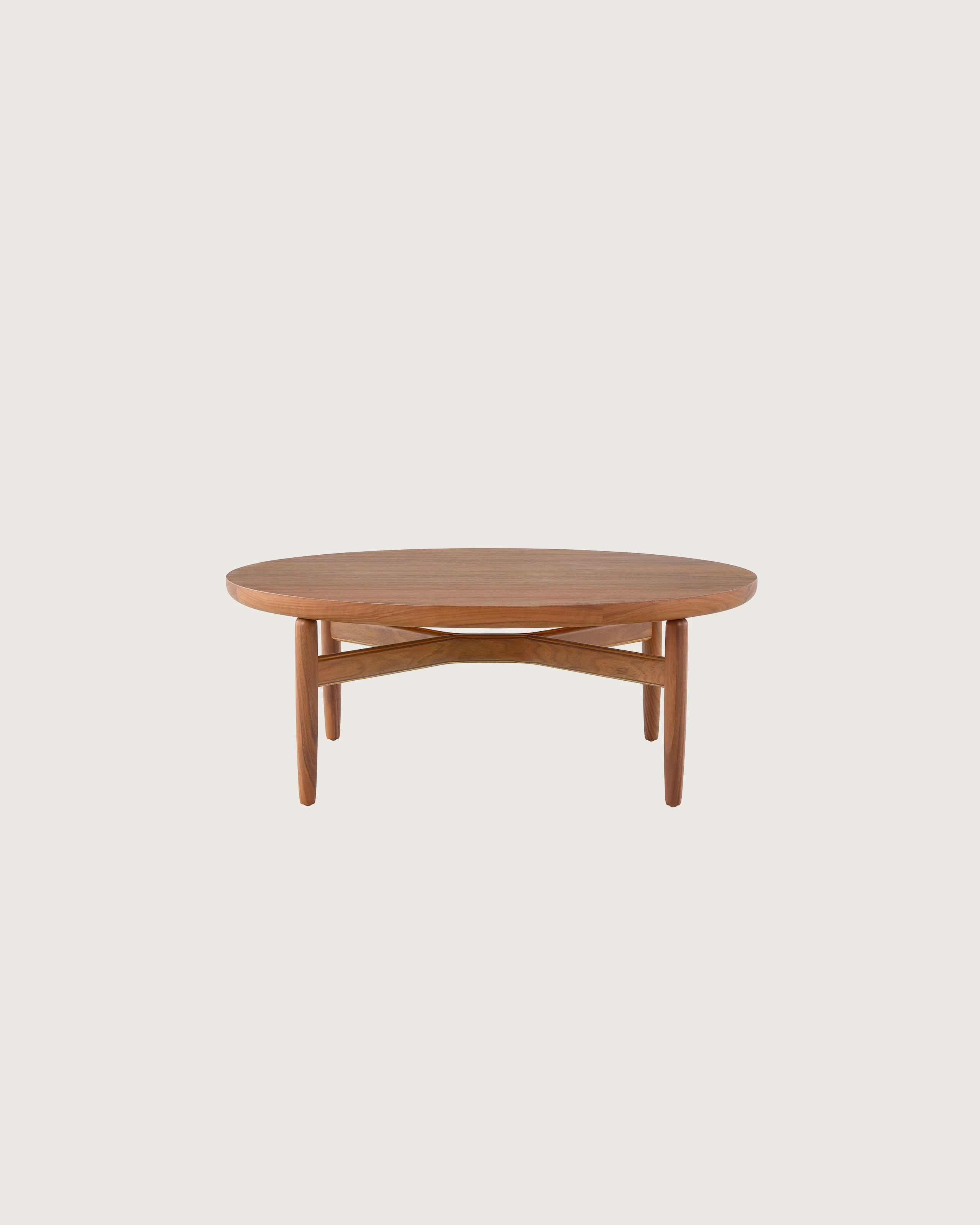 A Reframe Round Table in Walnut, viewed from the front.
