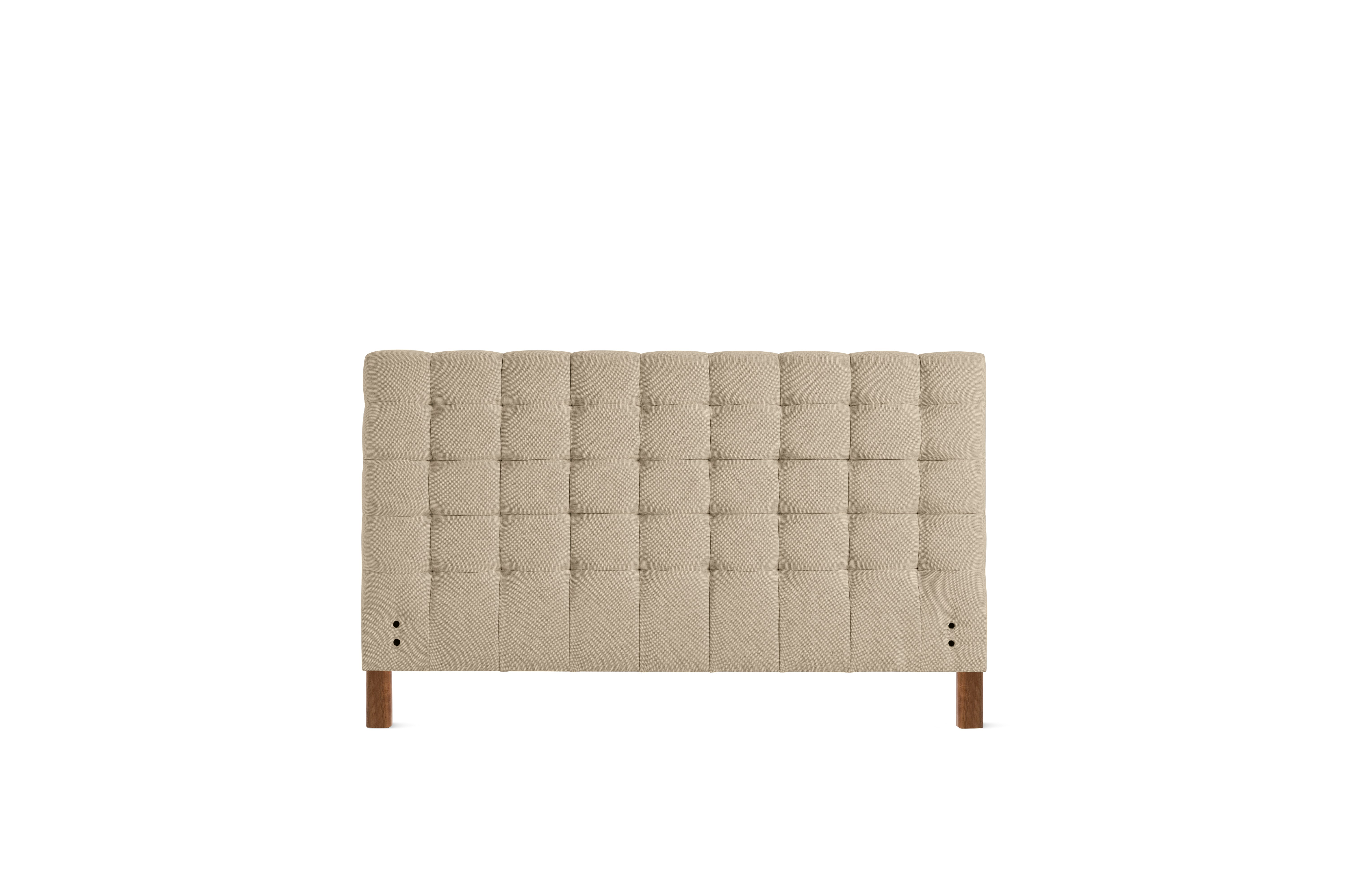 A Madeleine Headboard in Mode, Basket, Walnut viewed from the front.