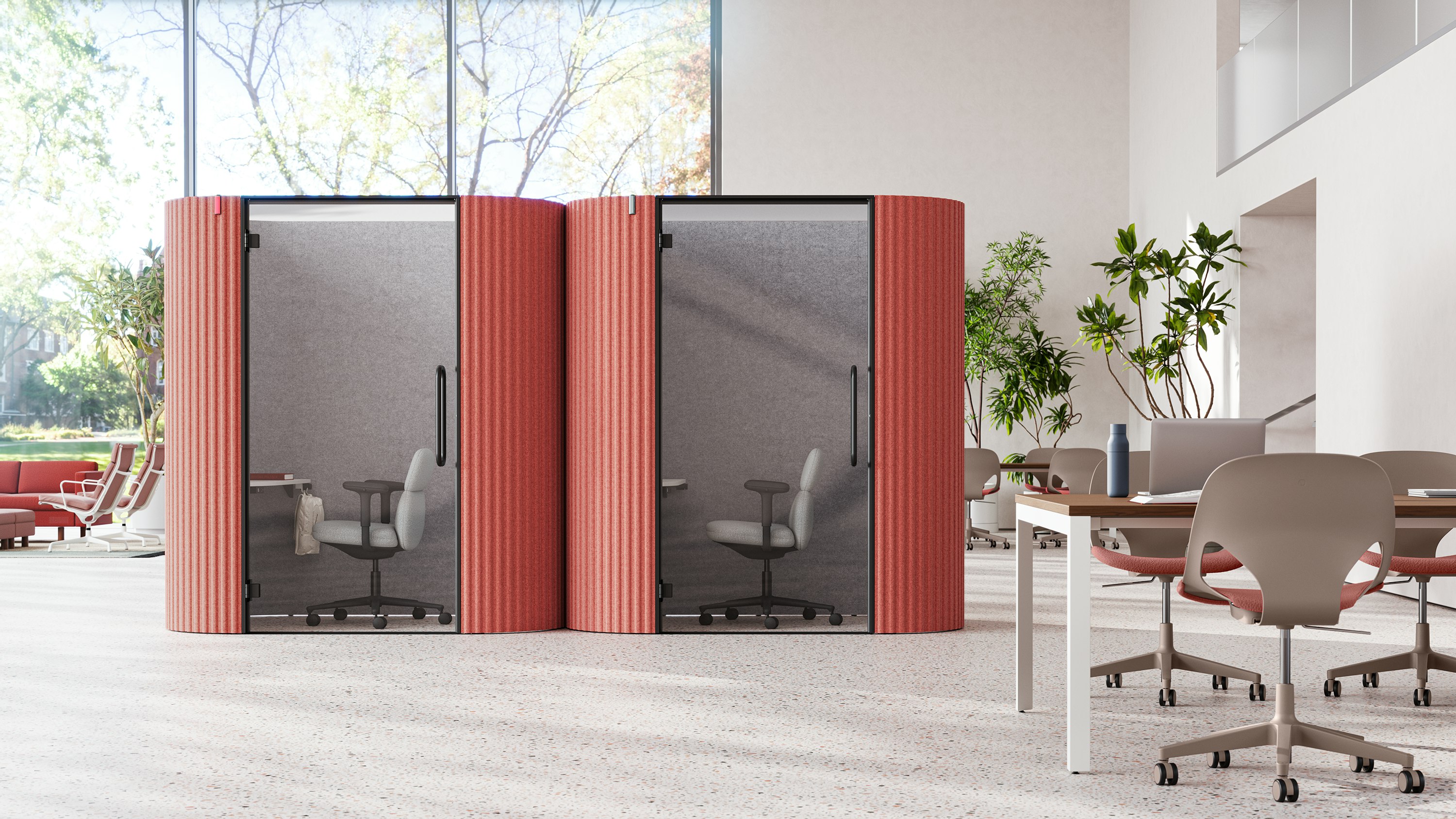 Two Bay Work Pod Pro units in a large and airy plaza, with a lounge space on one side and workstations on the other.