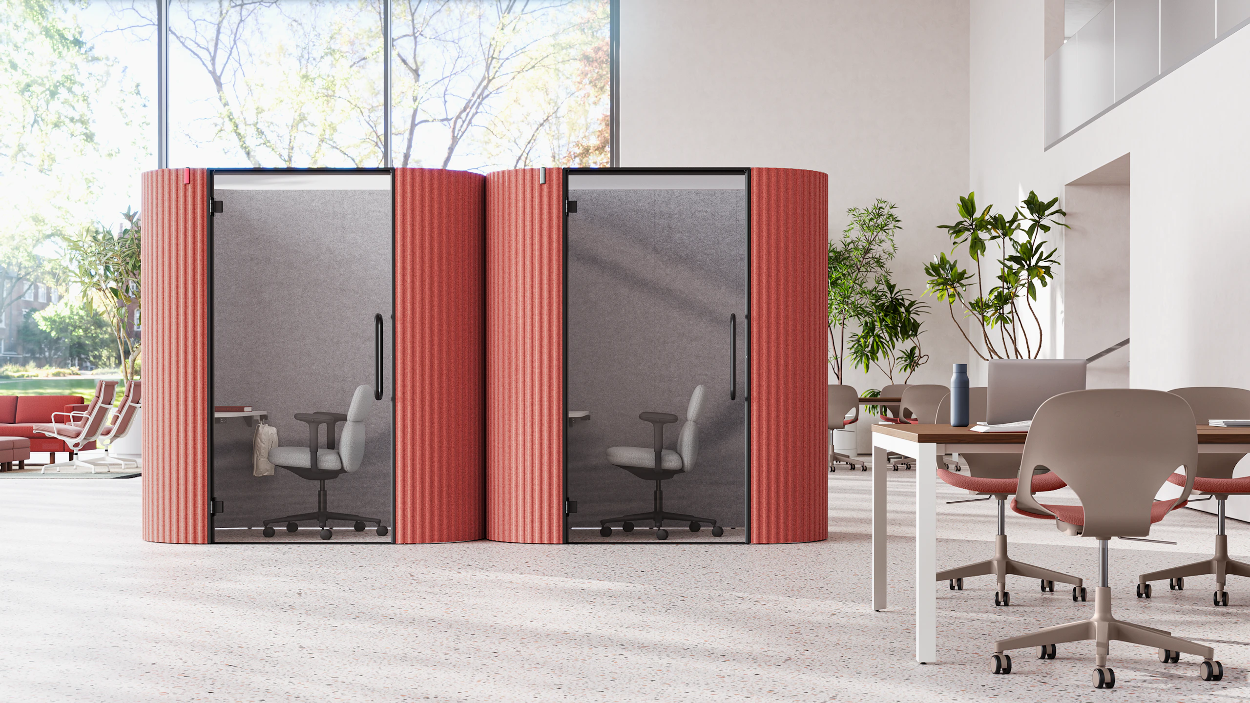 Two Bay Work Pod Pro units in a large and airy plaza, with a lounge space on one side and workstations on the other.