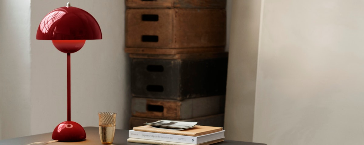 VP3 Flowerpot Table Lamp on a home office desk with books
