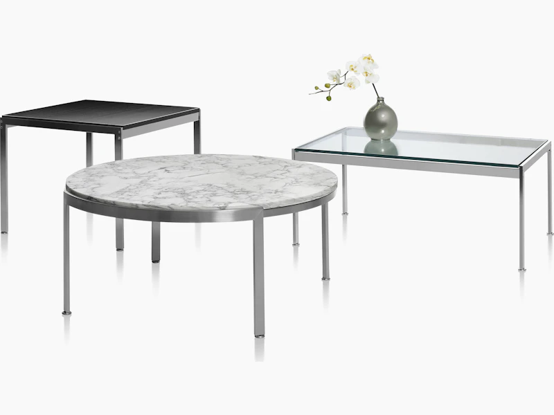 Partial view of a rectangular Metal Series coffee table with a glass top.