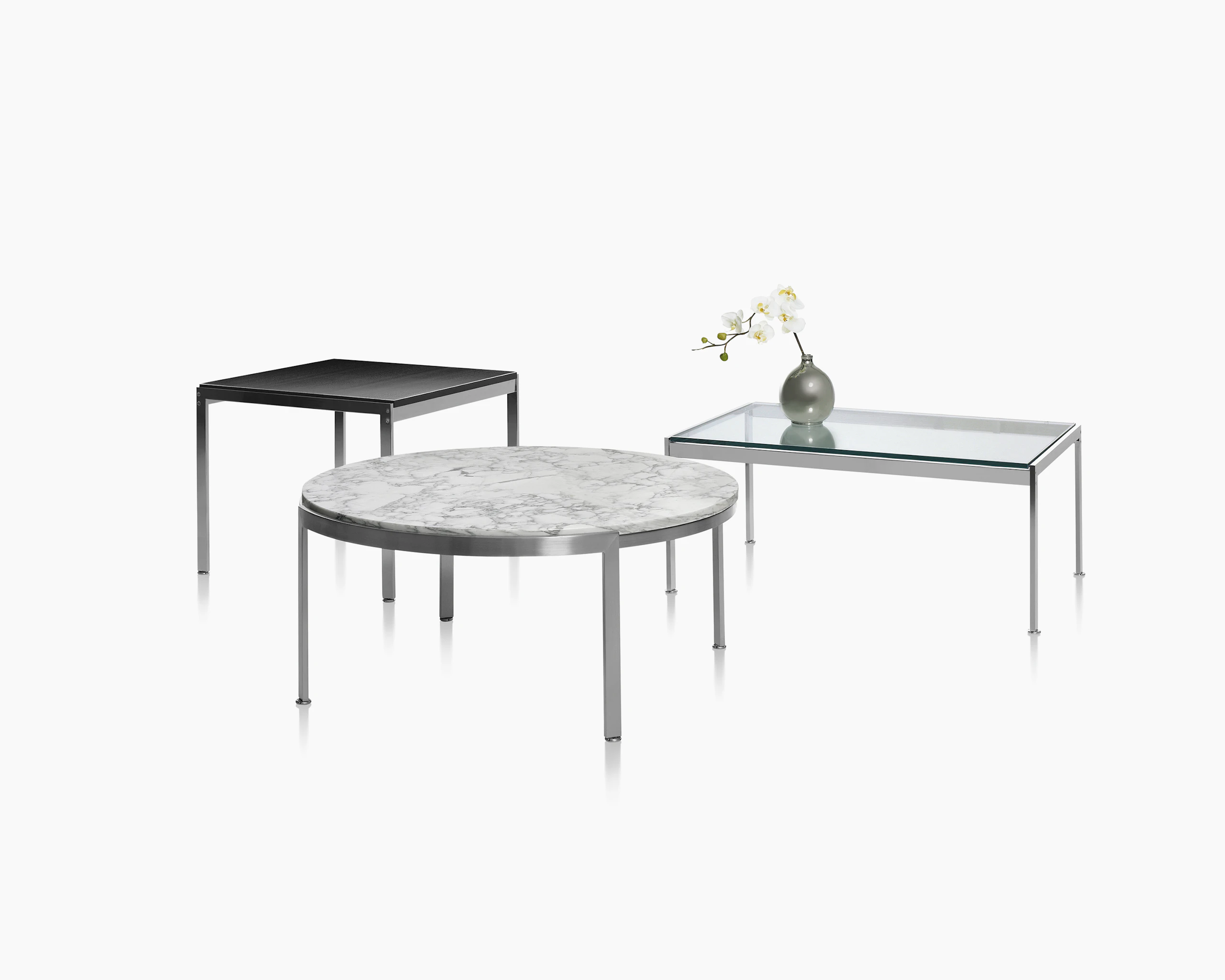 Partial view of a rectangular Metal Series coffee table with a glass top.