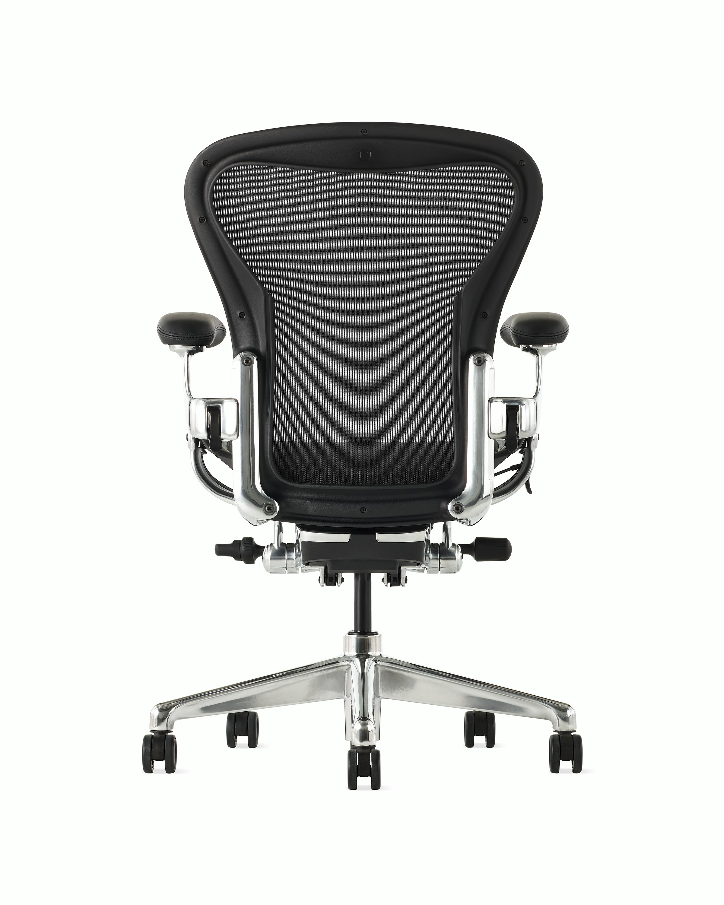 Black matte Aeron Chair on a white background with a polished aluminum 5-star base, chassis, and ergonomic back support, view of chair back.