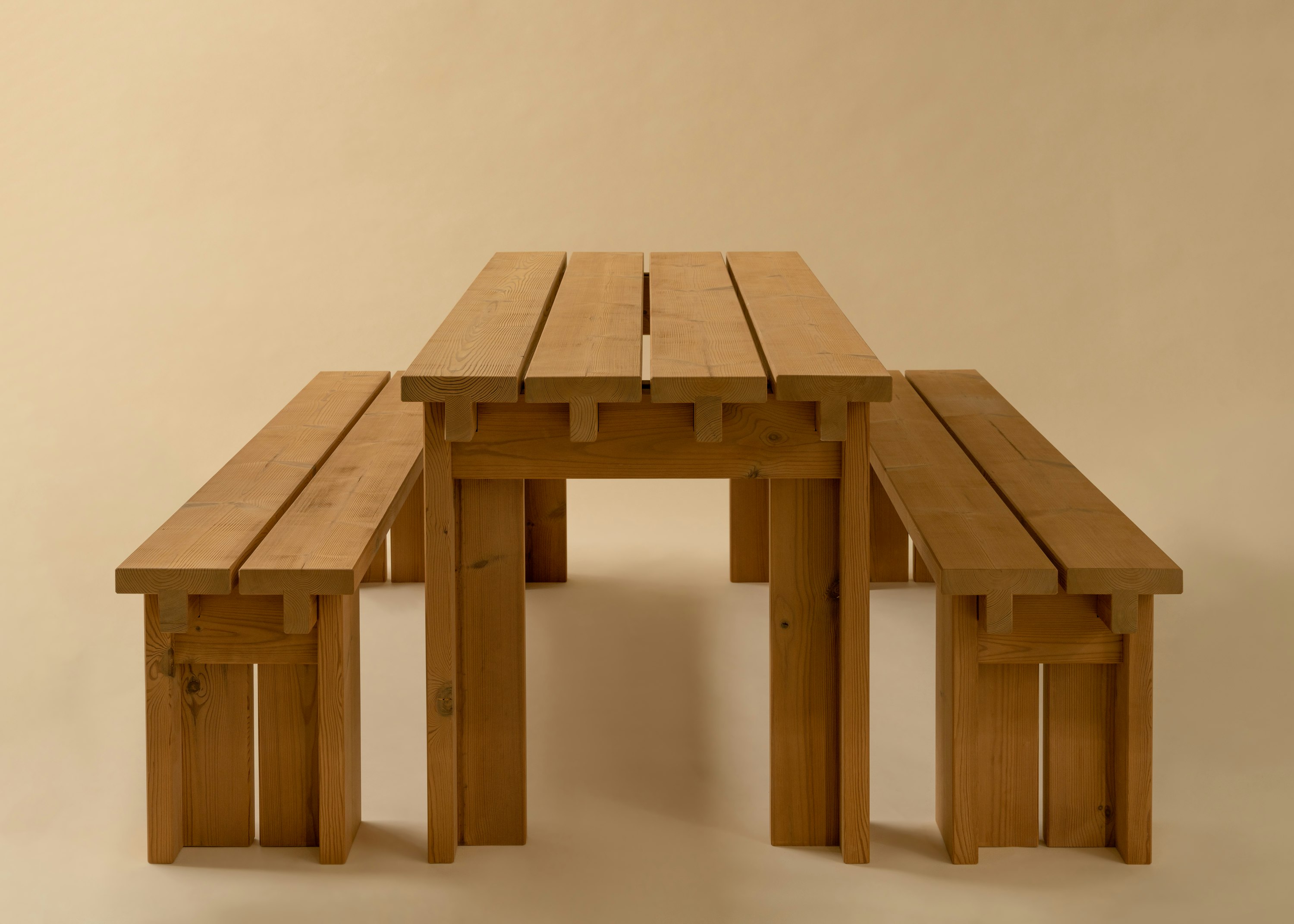 Closeup image of Osa Outdoor Dining Table and two Osa Outdoor Dining Benches