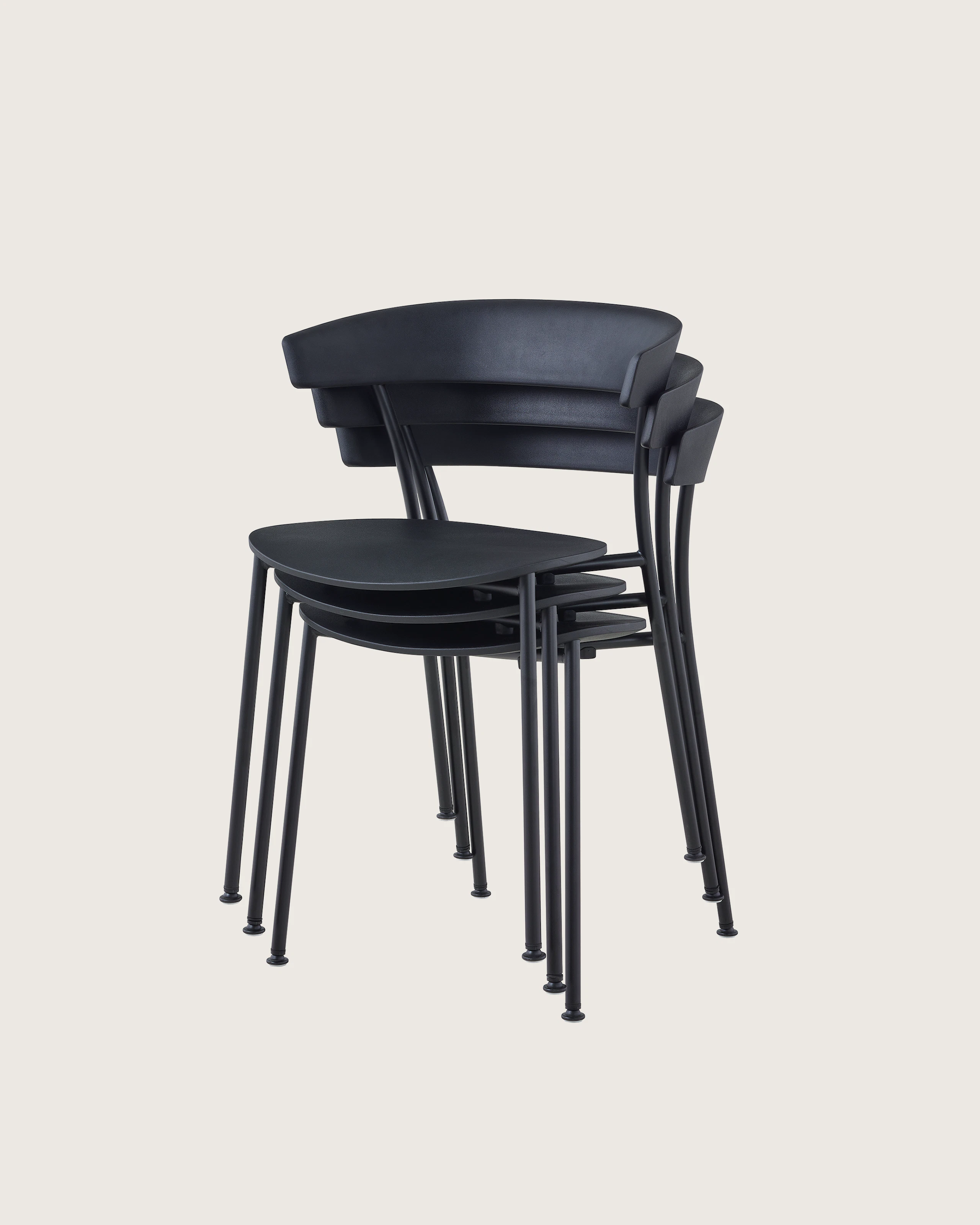 A three-quarter angle view of black Leeway Chairs stacked three high.