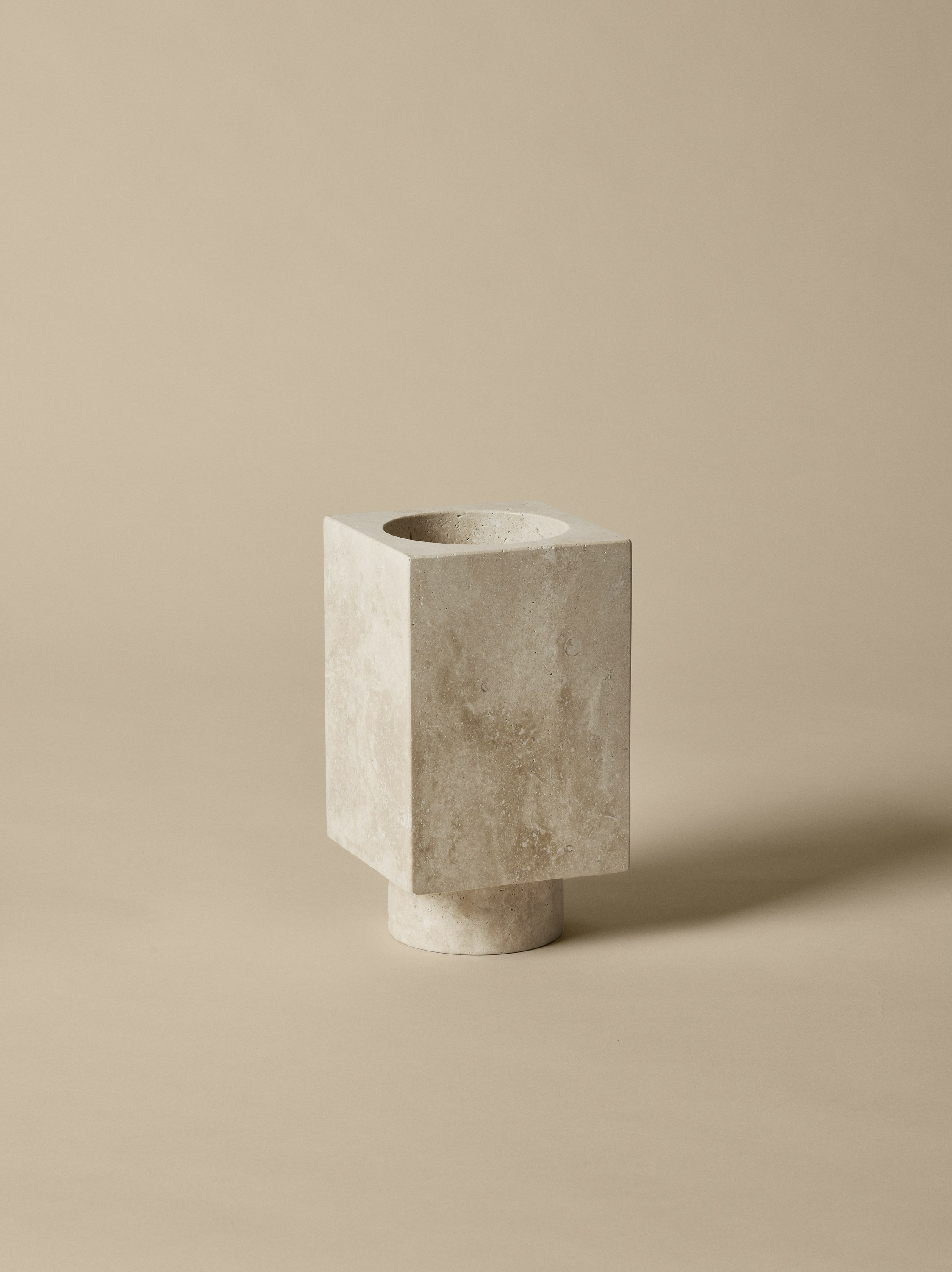 An environmental shot of Hew Travertine Vase.