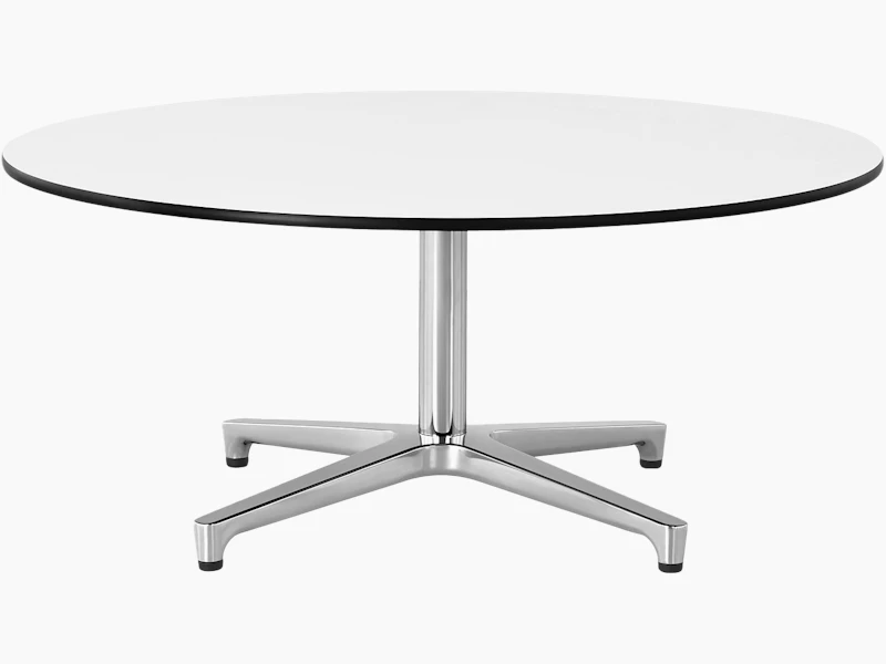 The upper portion of a round Saiba occasional table, showing the white back-painted glass top.