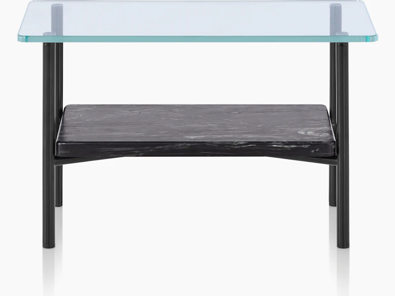 A Layer side table with a glass top and black marble lower shelf, viewed from the front.