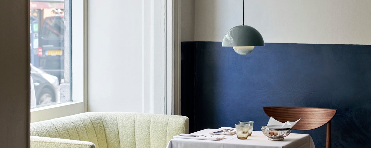 VP1 Flowerpot Pendant suspended over a dining table