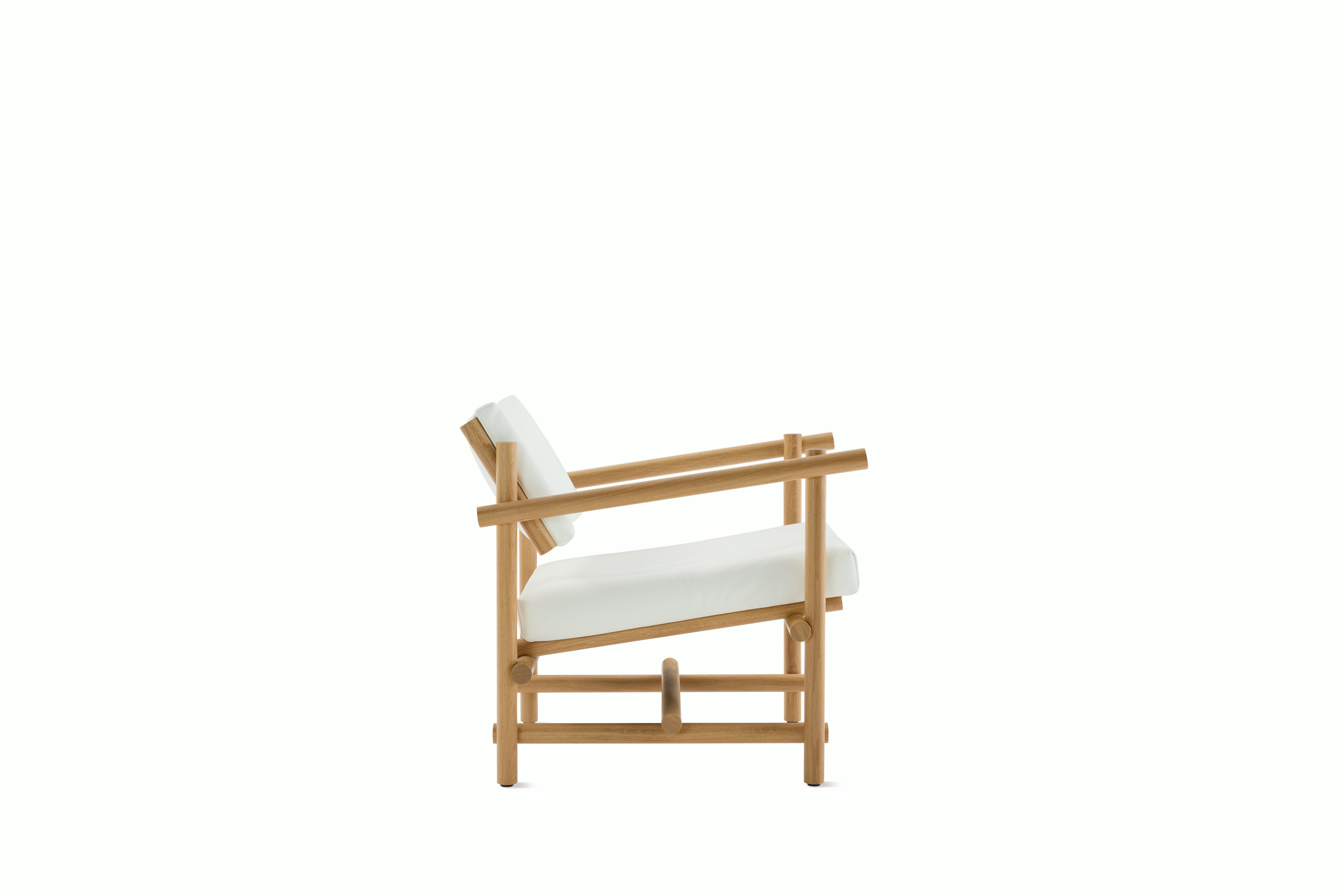 A Muecke Lounge Chair in White White Oak viewed from the side.