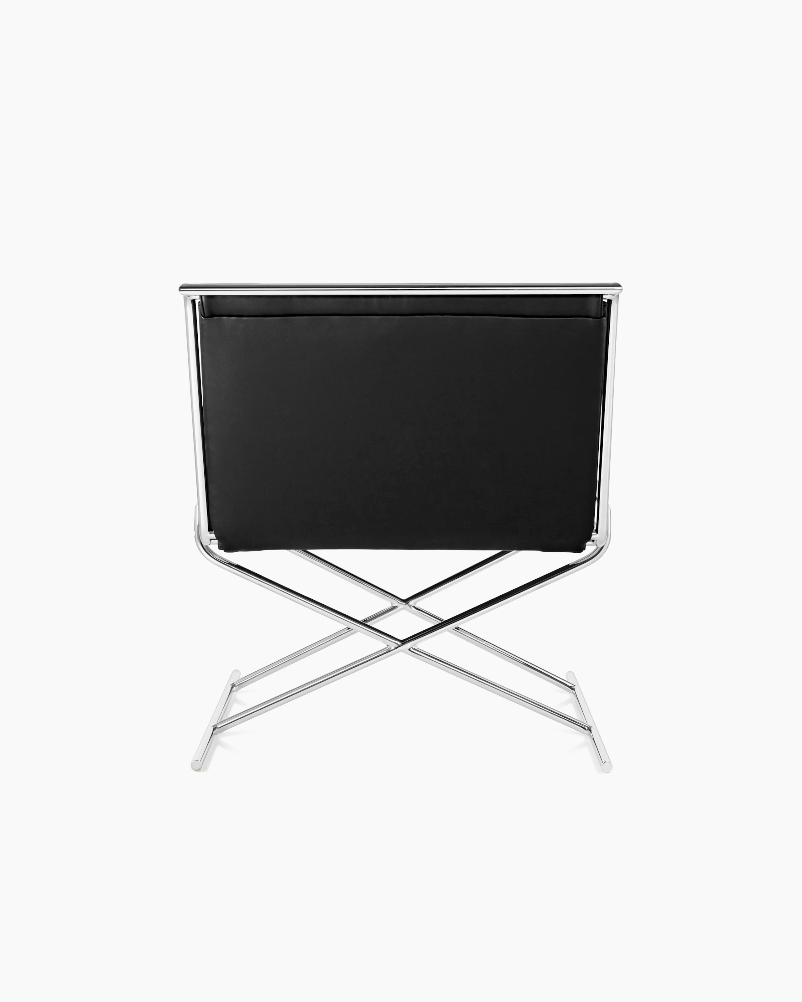 A Sled lounge chair with black leather upholstery and an X-shaped steel frame, viewed from behind.