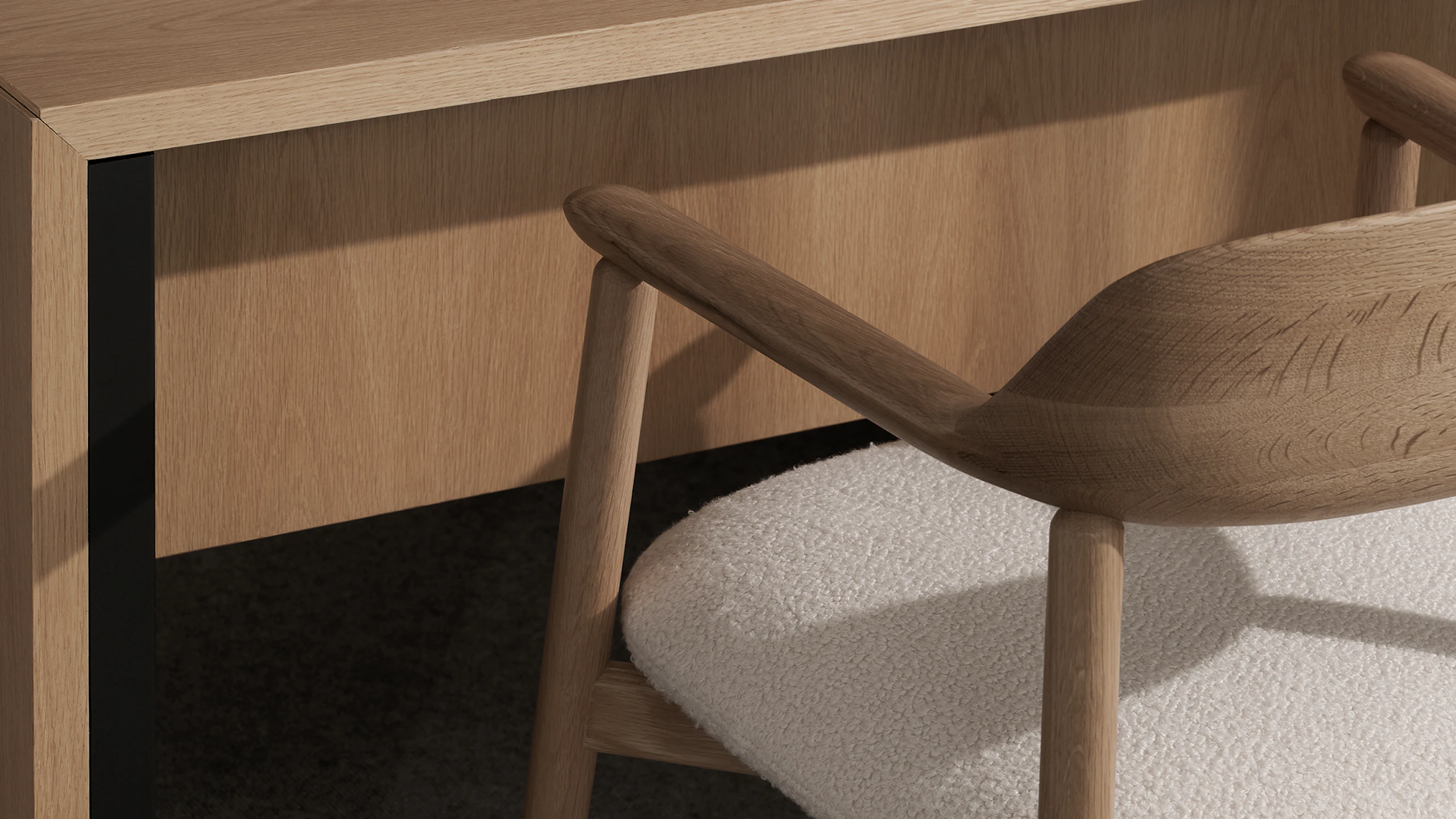 Detail view of a Geiger One Private Office cascade leg in Natural Flat Cut Oak with a Crosshatch Side Chair in Natural Oak upholstered with Maharam Firth in Limewash, viewed at an angle.
