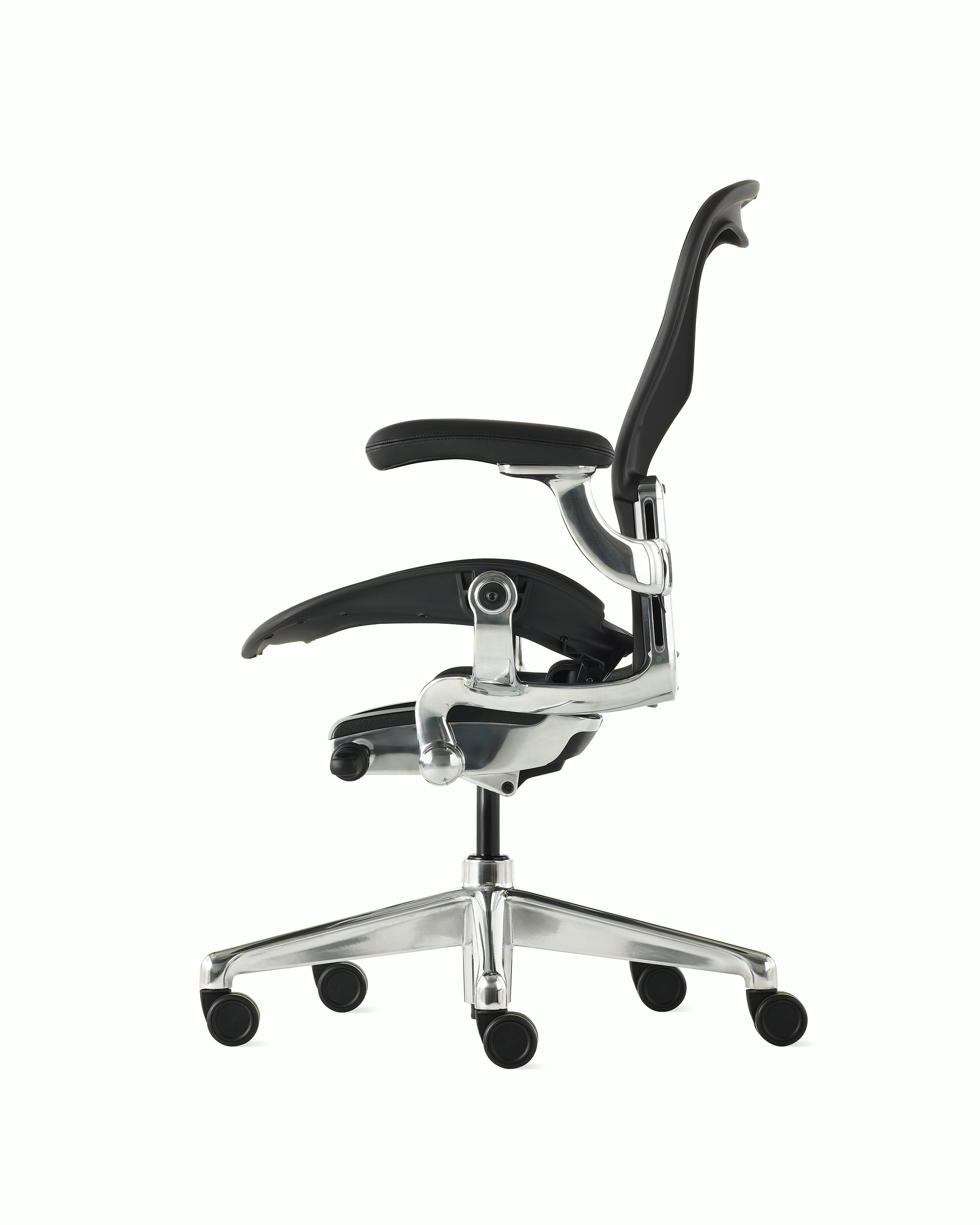 Black matte Aeron Chair on a white background with a polished aluminum 5-star base, chassis, and ergonomic back support, viewed from the side.