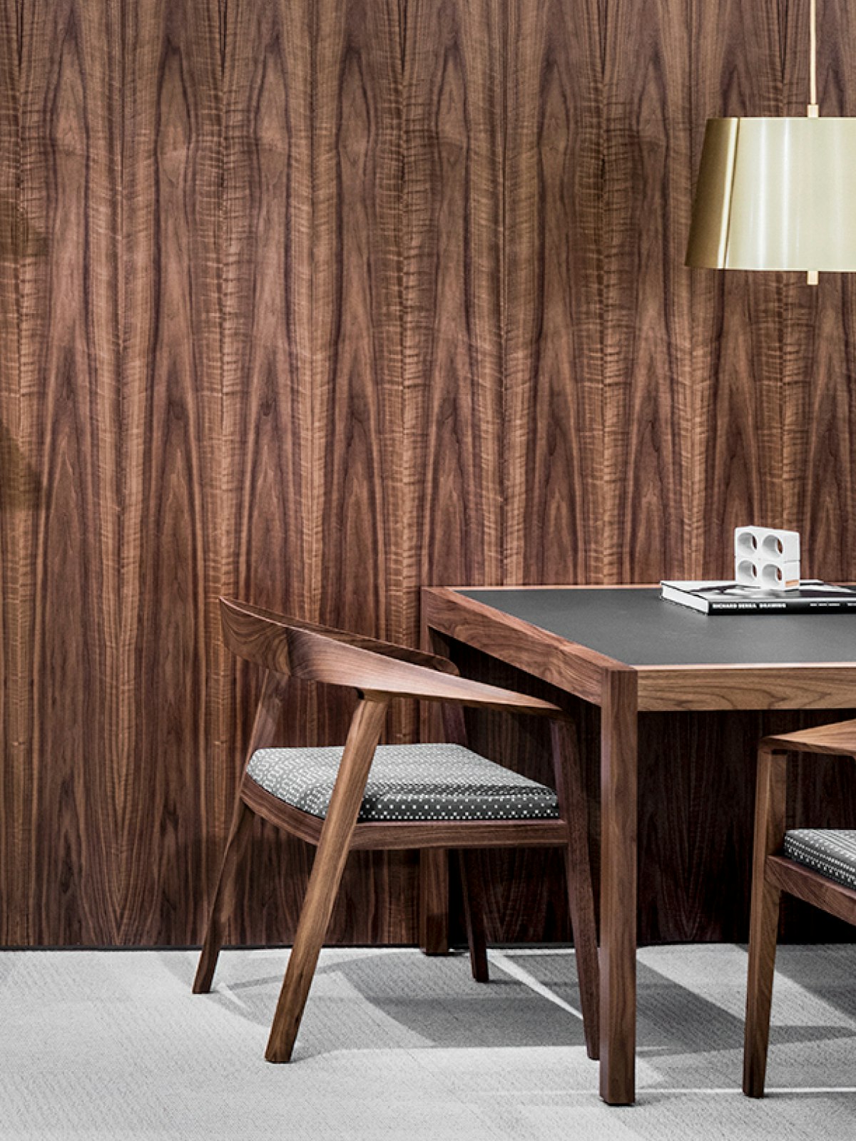 Full Twist chairs that coordinate with the wood finish on the wall and table.