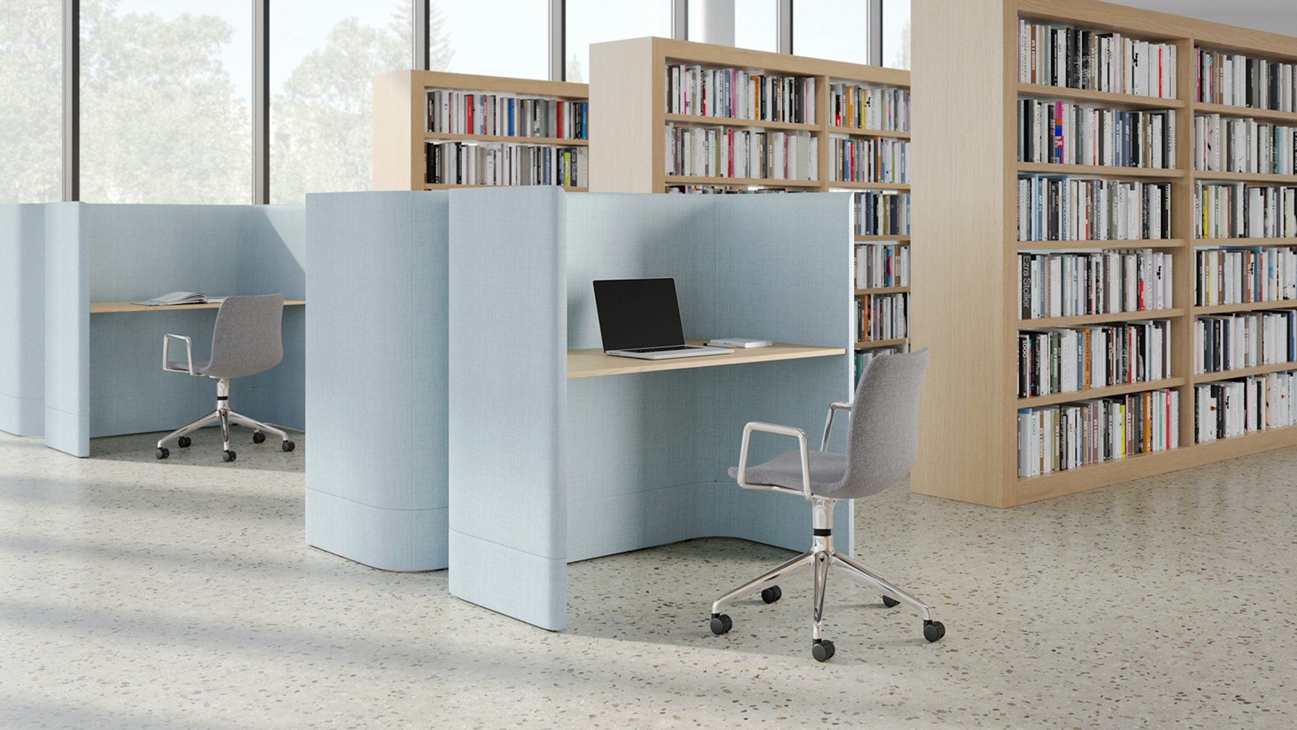 Grey NaughtOne Viv chair at a light blue Herman Miller Pullman desk in a library.