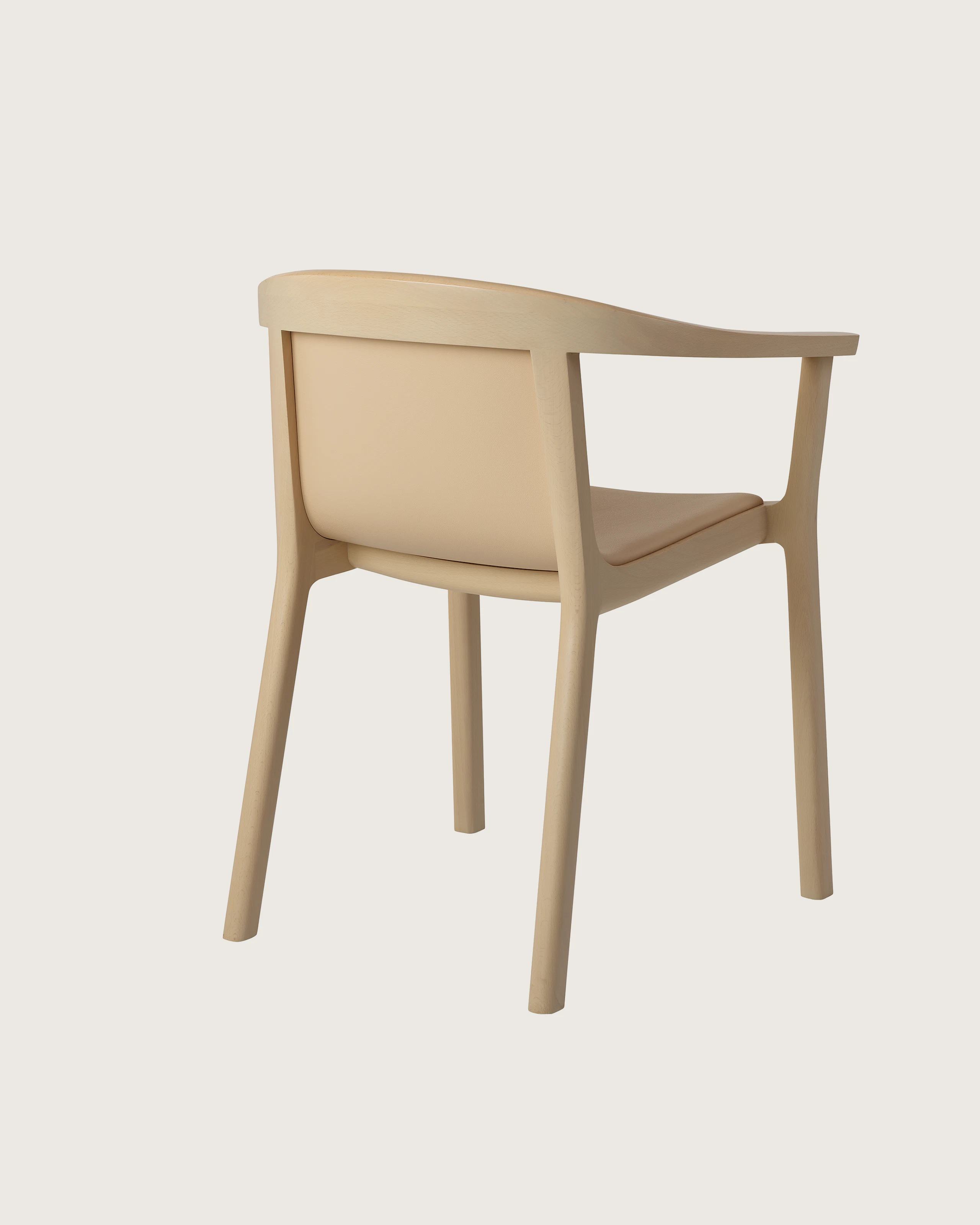 Lijn Armchair by Carole Baijings for Geiger in Light Beech frame upholstered with Maharam Prone Leather in Balsa, angled back view on a white sweep.