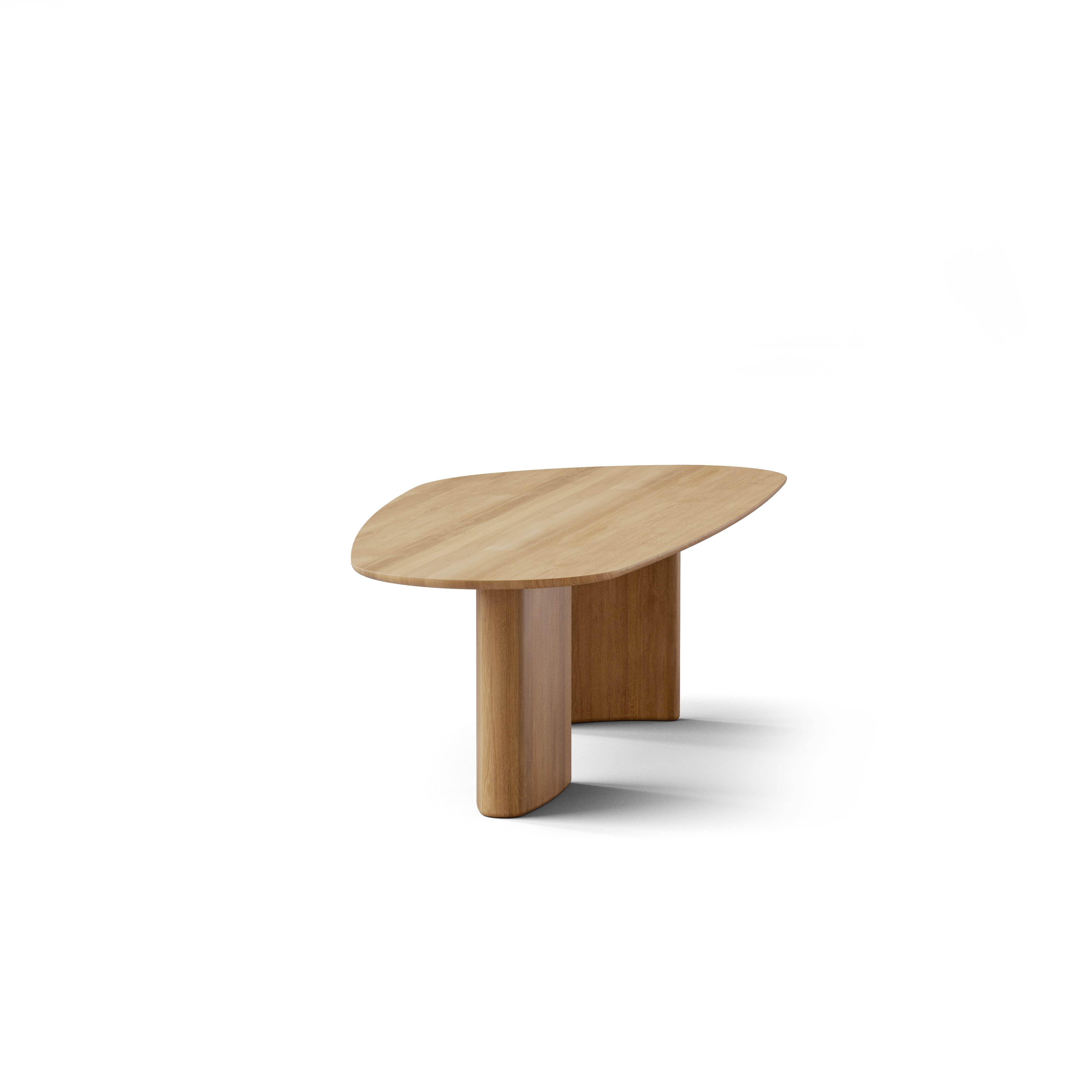 A Tangent Dining Table in Oak viewed from the side.