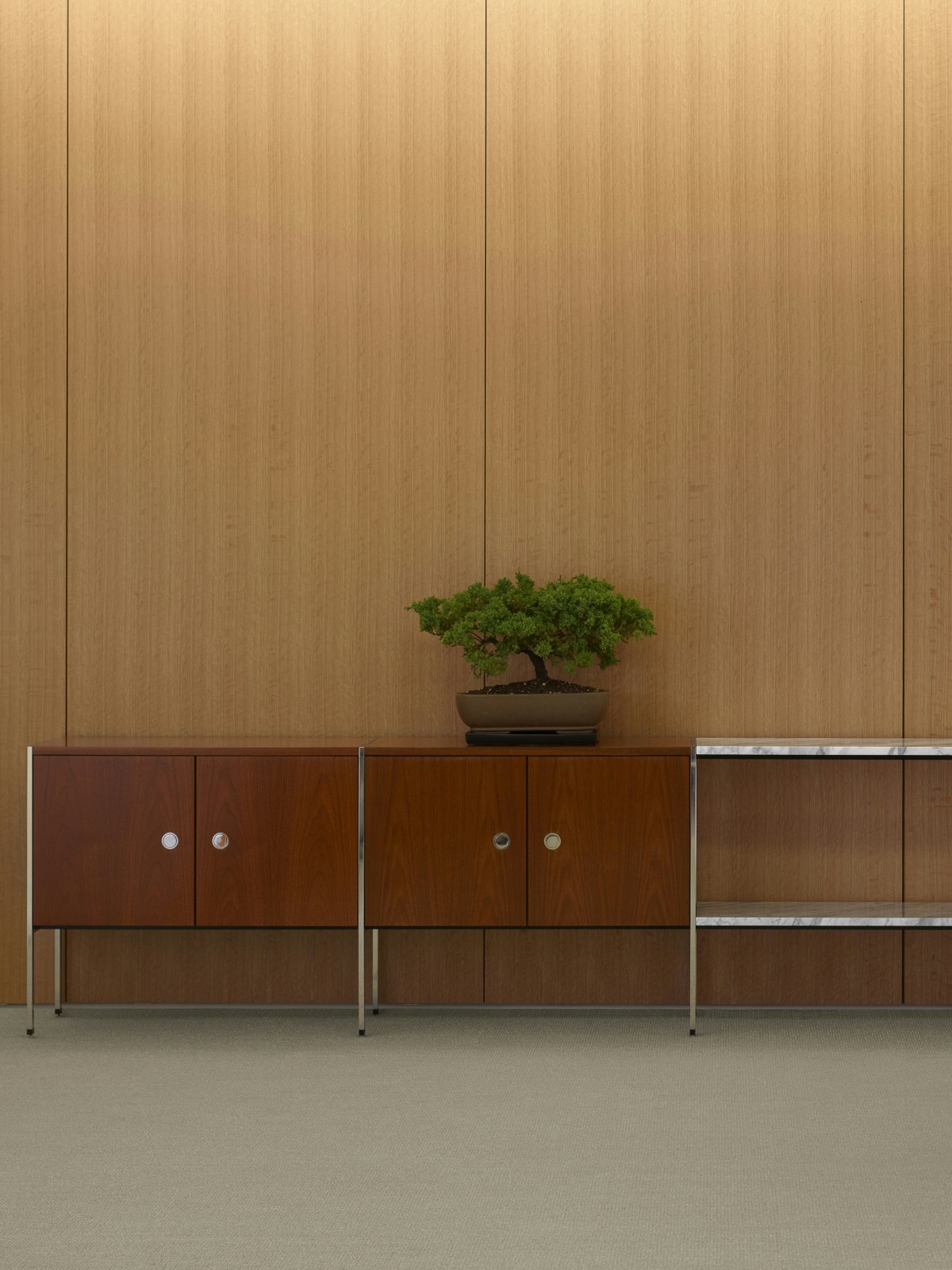 Partial view of an H Frame Storage credenza with enclosed cabinets and open shelving modules.
