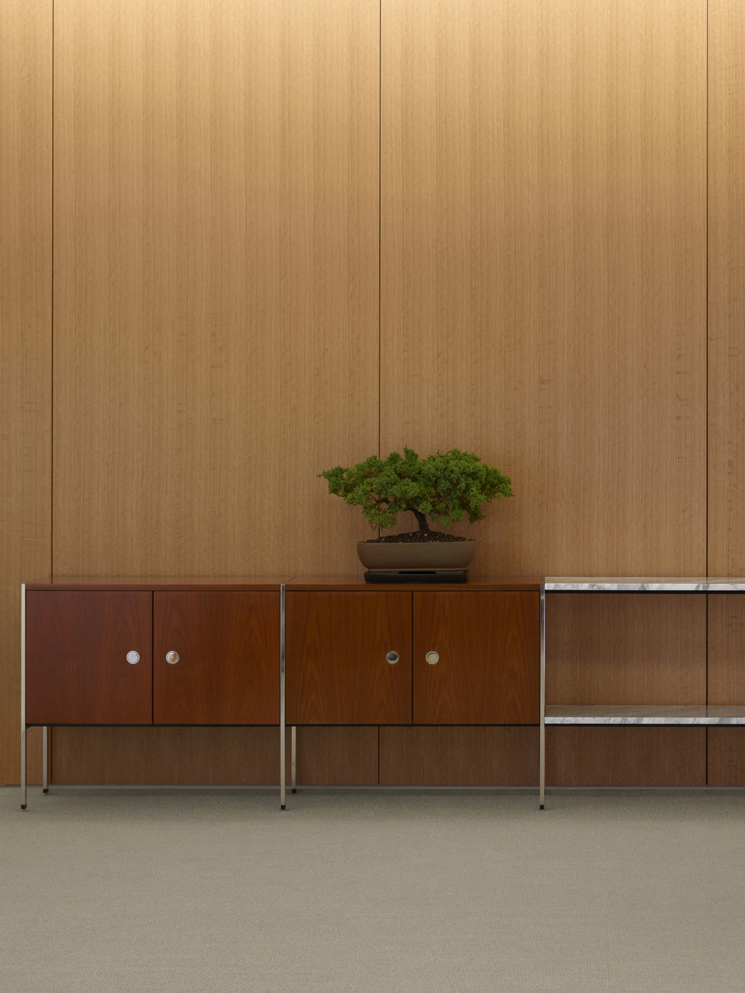 Partial view of an H Frame Storage credenza with enclosed cabinets and open shelving modules.