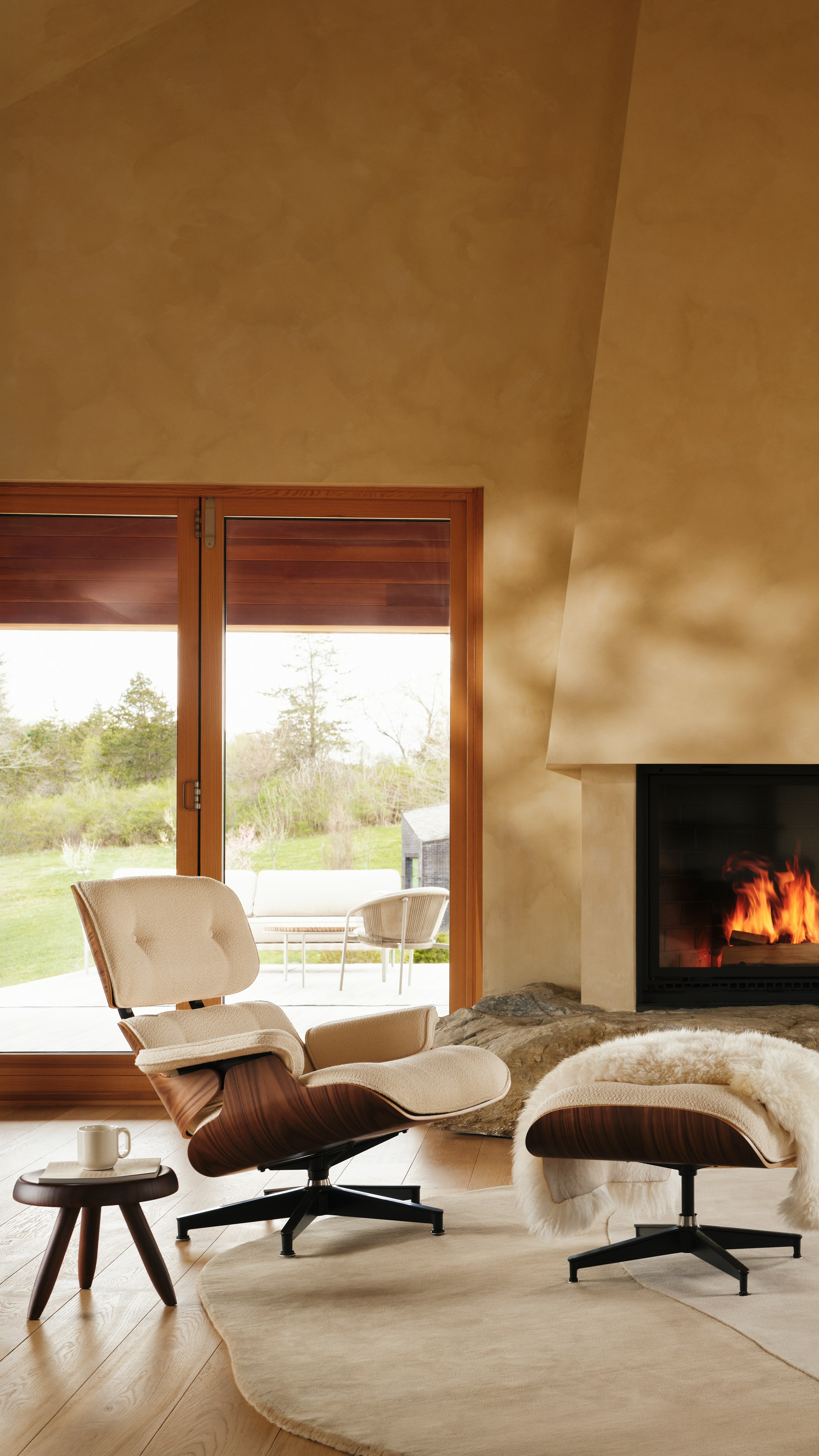 Eames Lounge and Ottoman in Cream boucle in frnot a fireplace