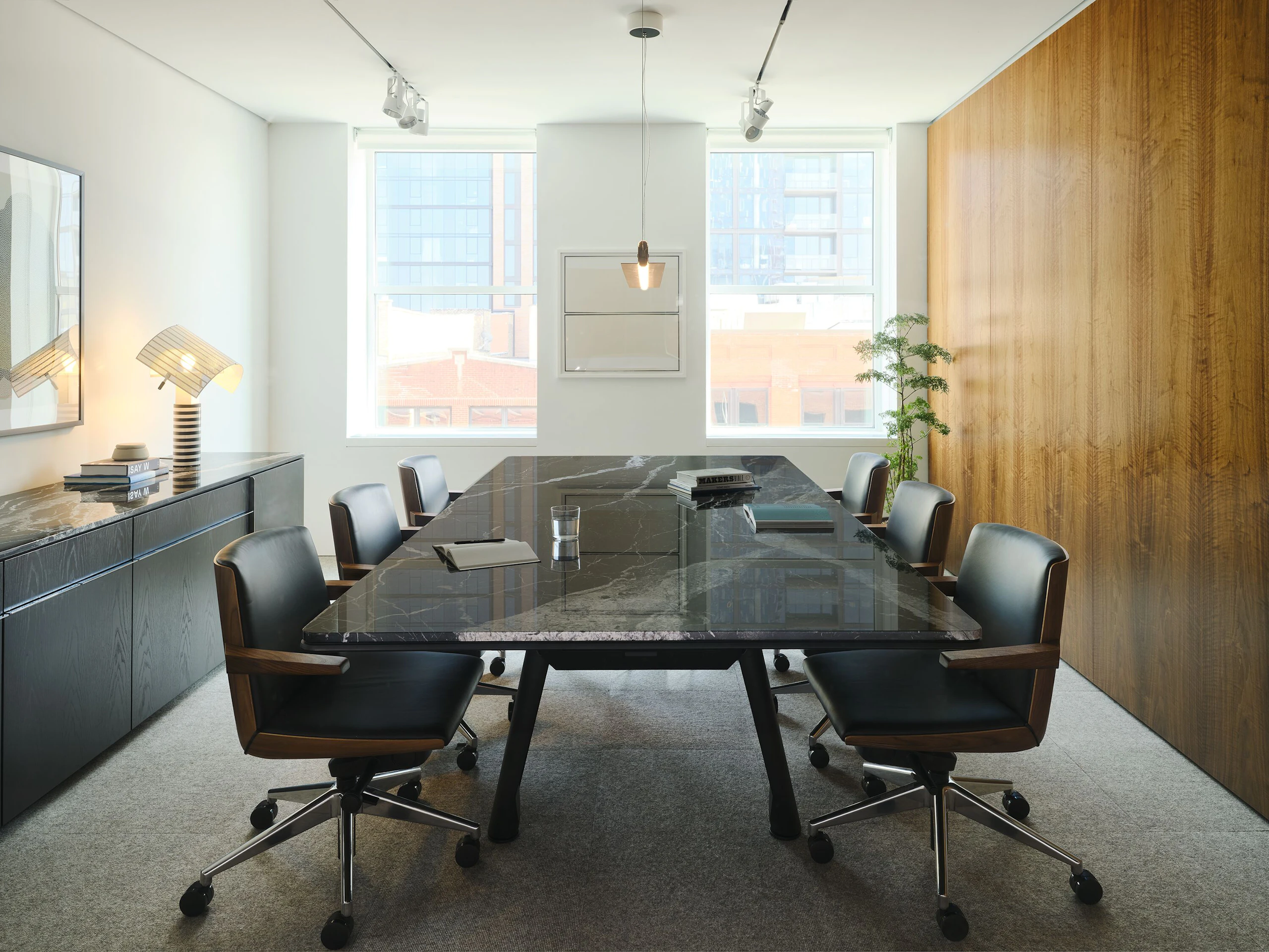 Ascent Conference Table in Nero Marquina Marble and Credenza in Ebonized Oak, both designed by EOOS, with Geiger Clamshell Chairs designed by BassamFellows shown