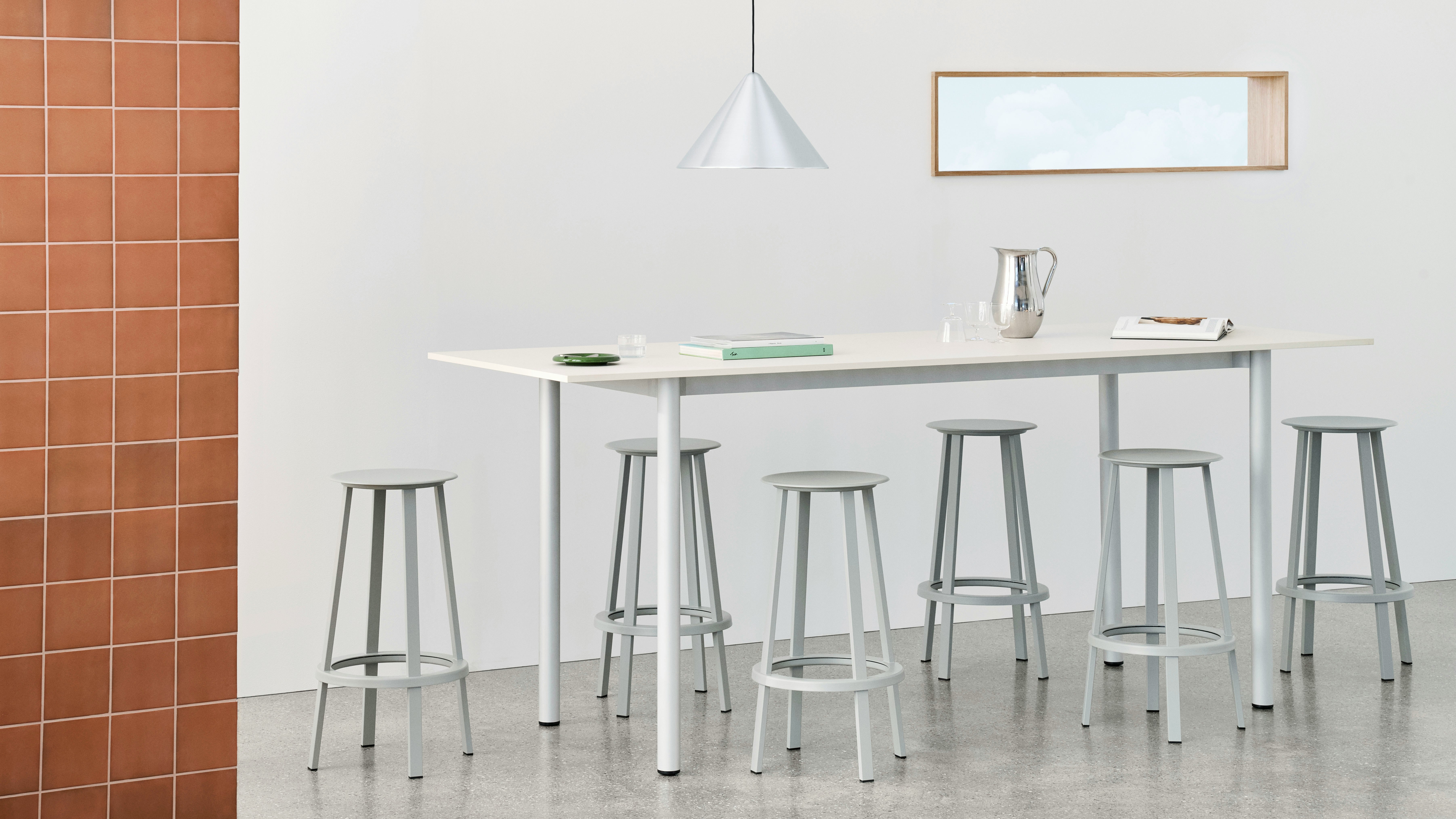 Annex Overhang table in white with Revolver barstools.