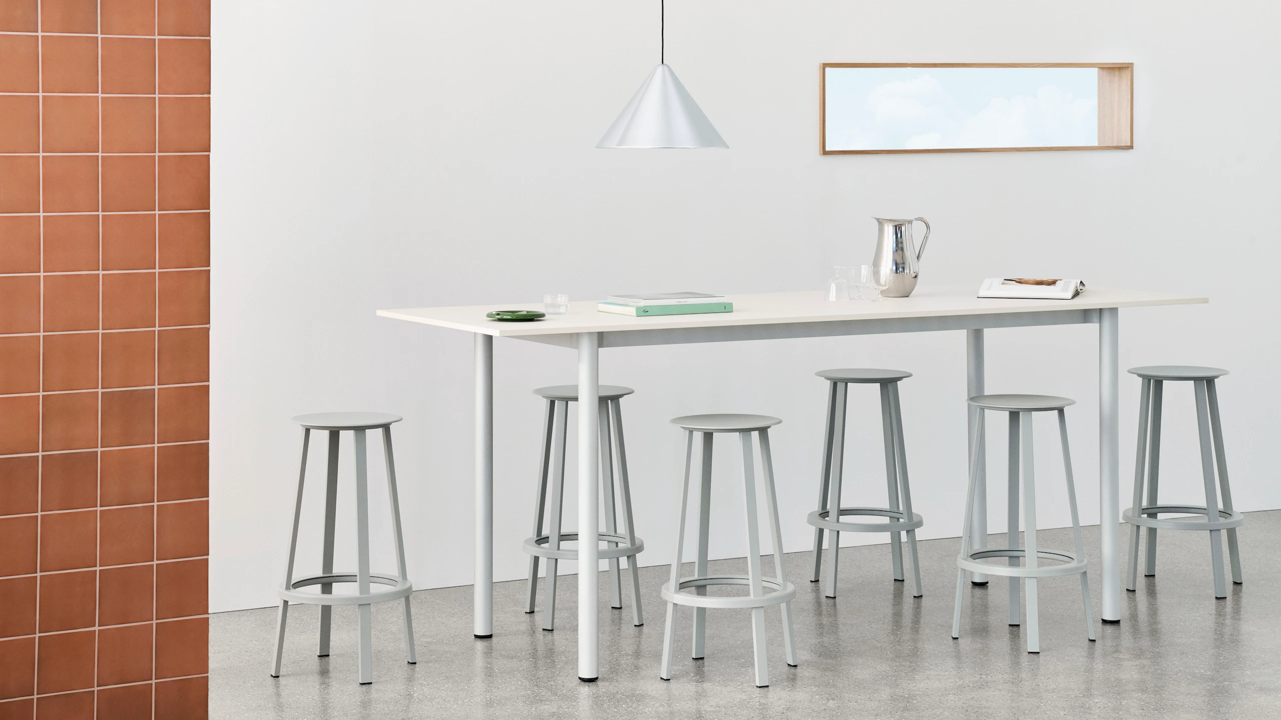 Annex Overhang table in white with Revolver barstools.