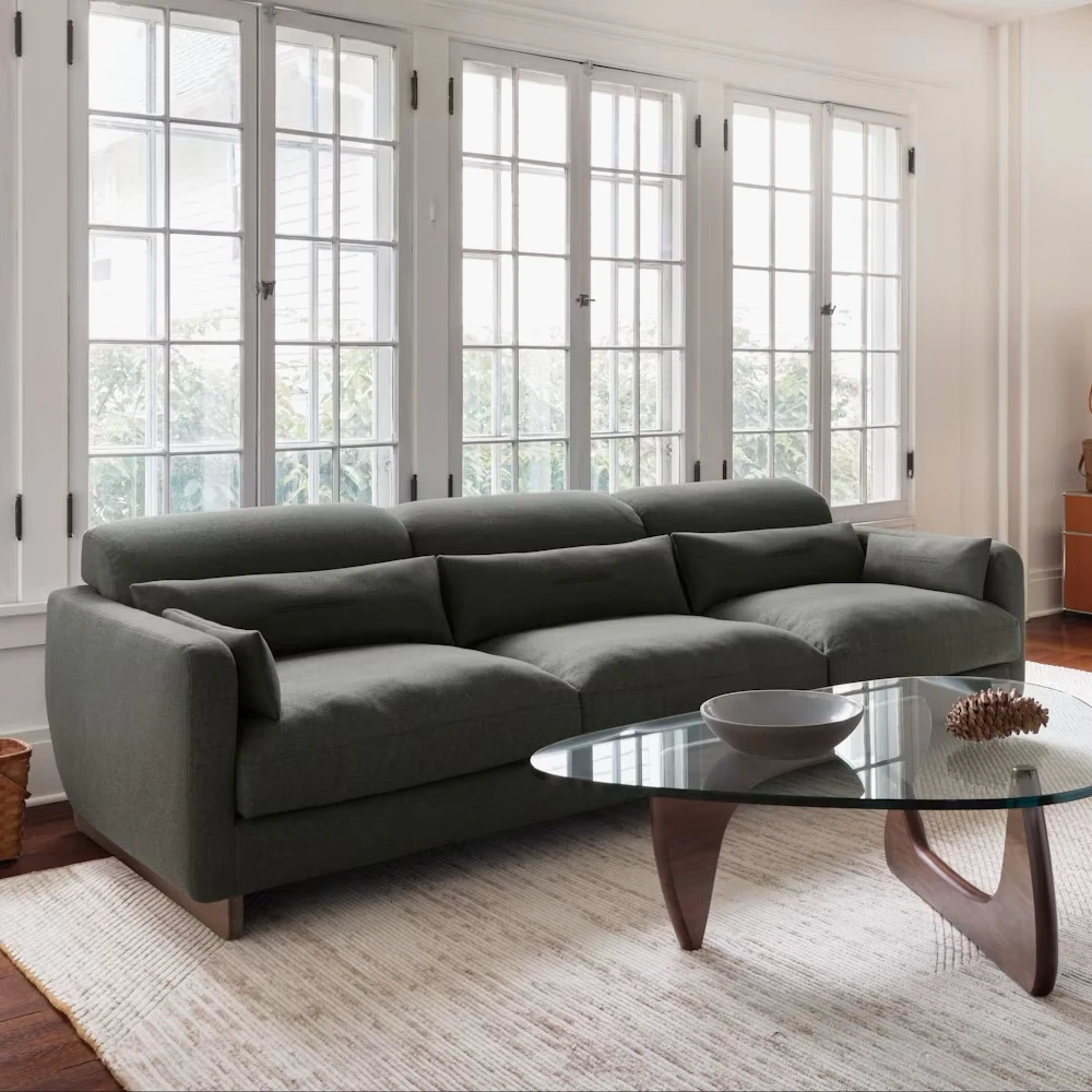 Wide shot of sofa in bright living room setting