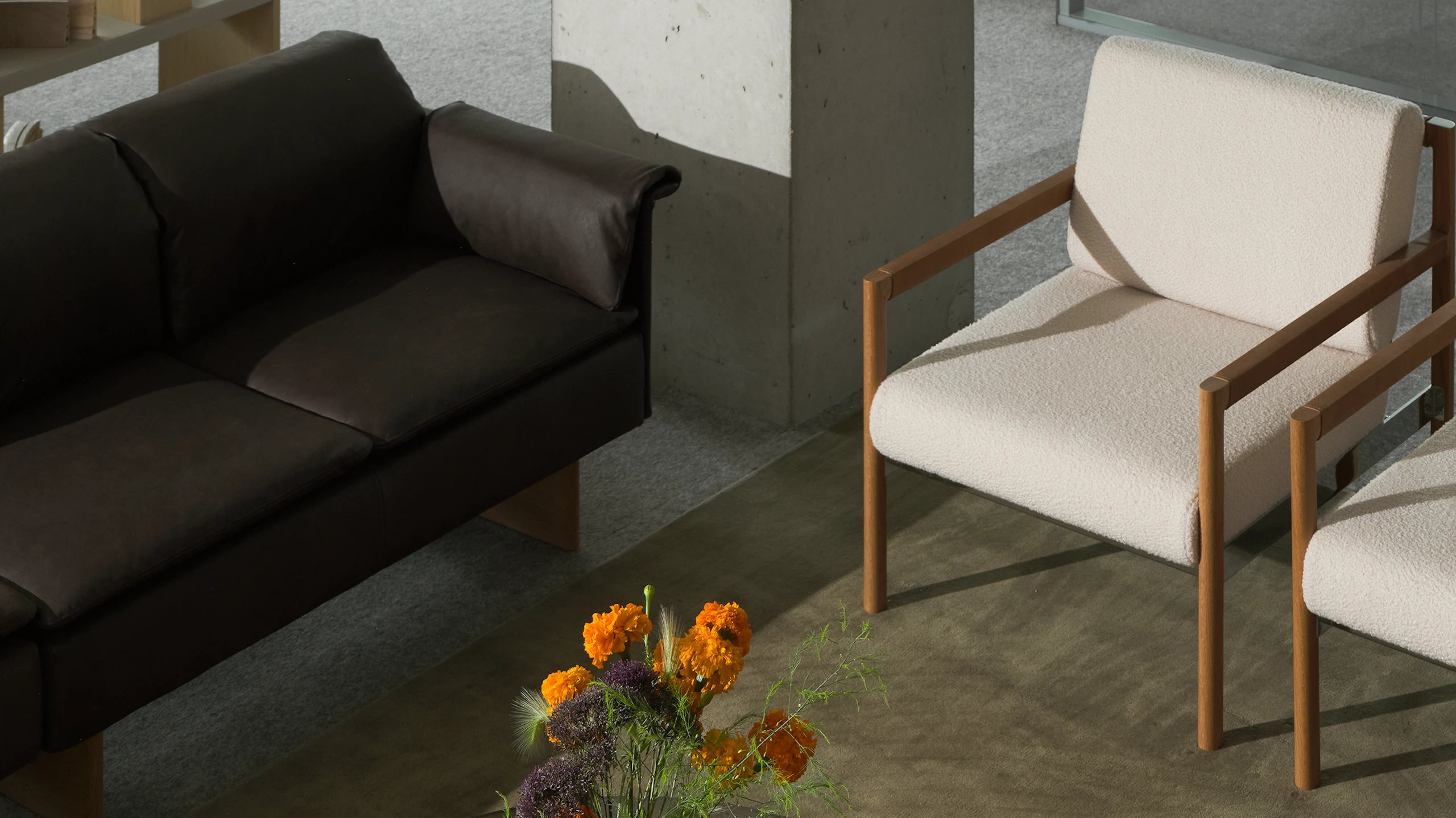 Lounge setting with two round Claw Tables, two Brabo Club Chairs, a Mantle Sectional Sofa, and a Sled Chair, viewed from above at an angle.