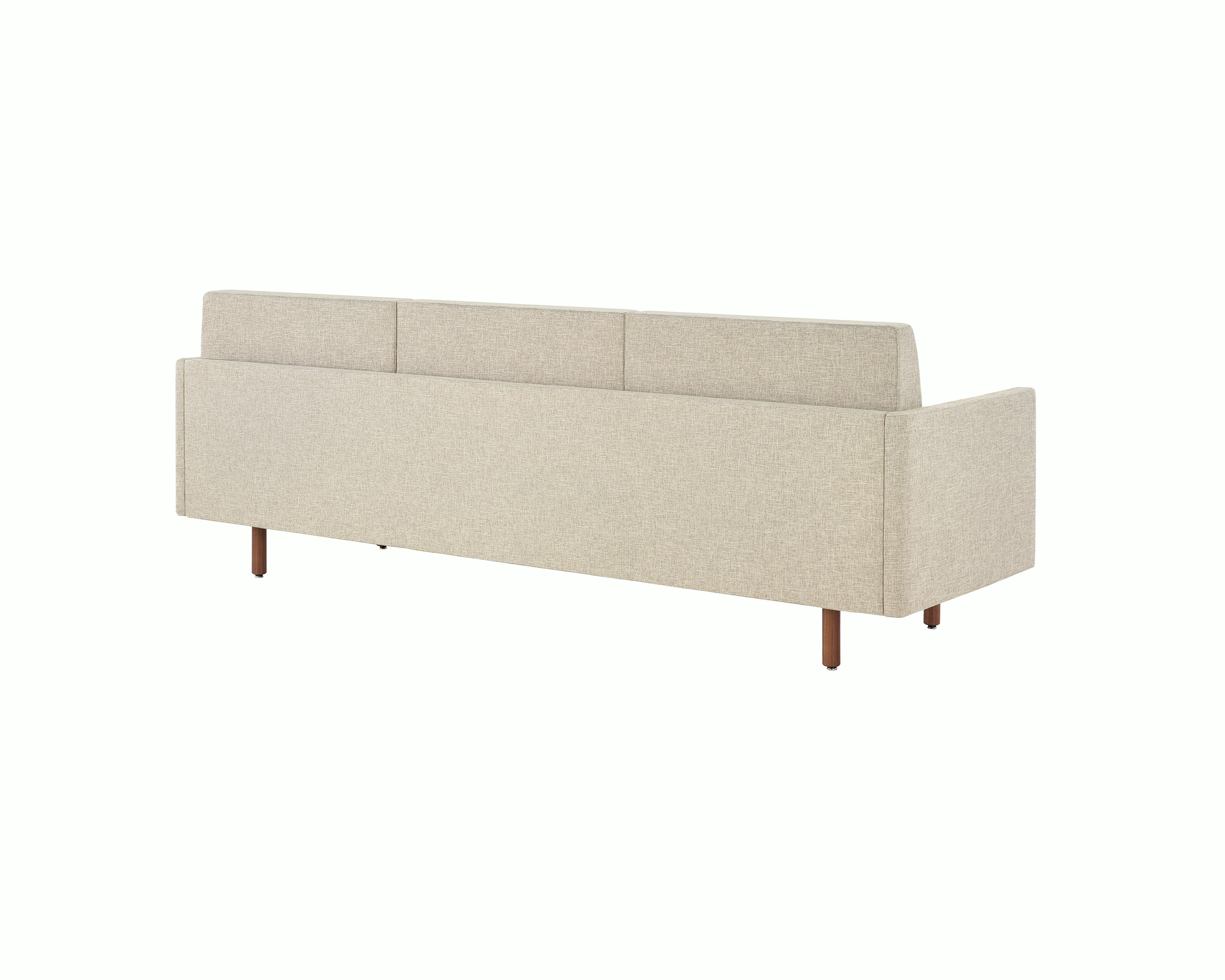 A Tuxedo Classic sofa with bone-colored quilted upholstery, viewed at an angle from behind.