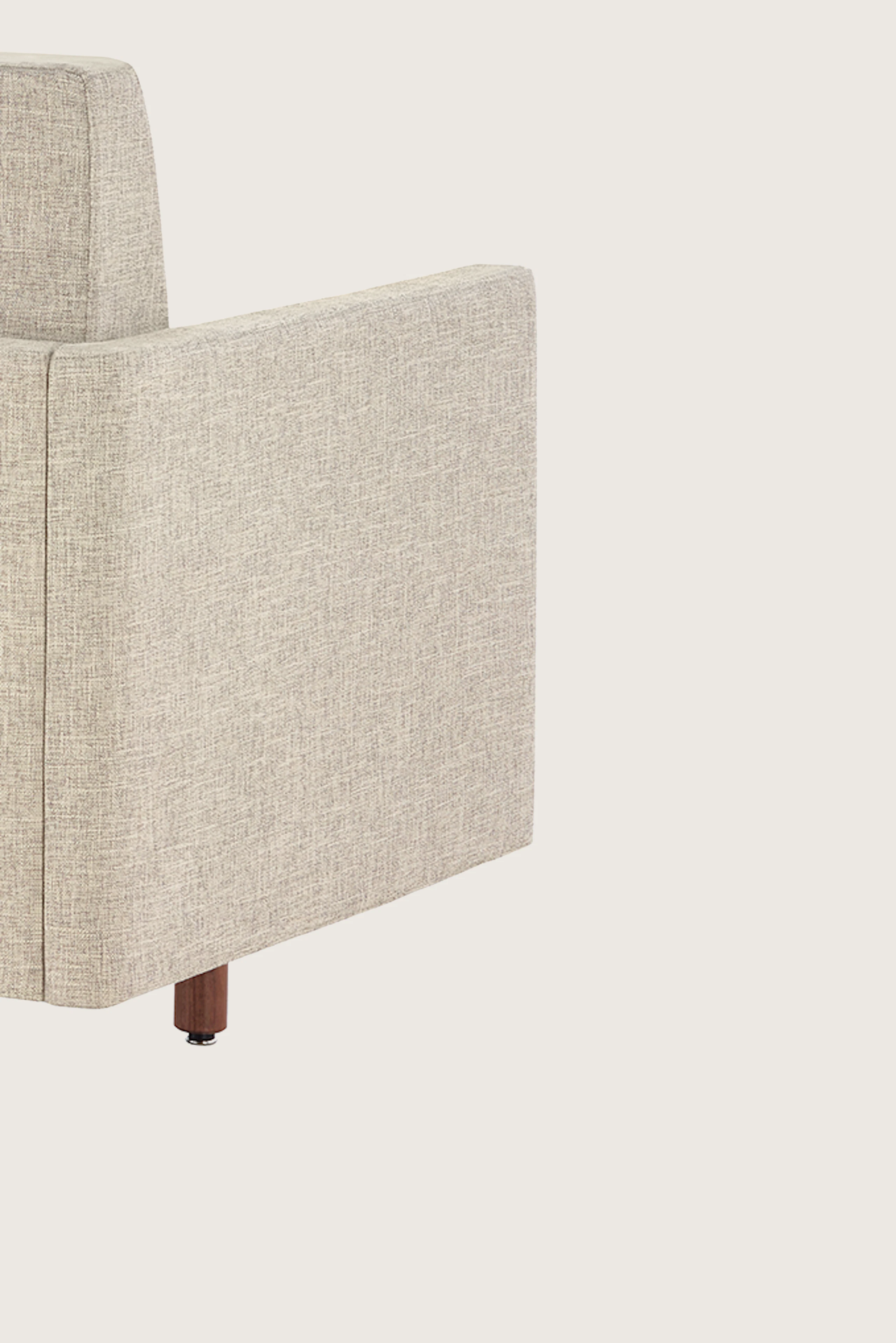 A Tuxedo Classic sofa with bone-colored quilted upholstery, viewed at an angle from behind.