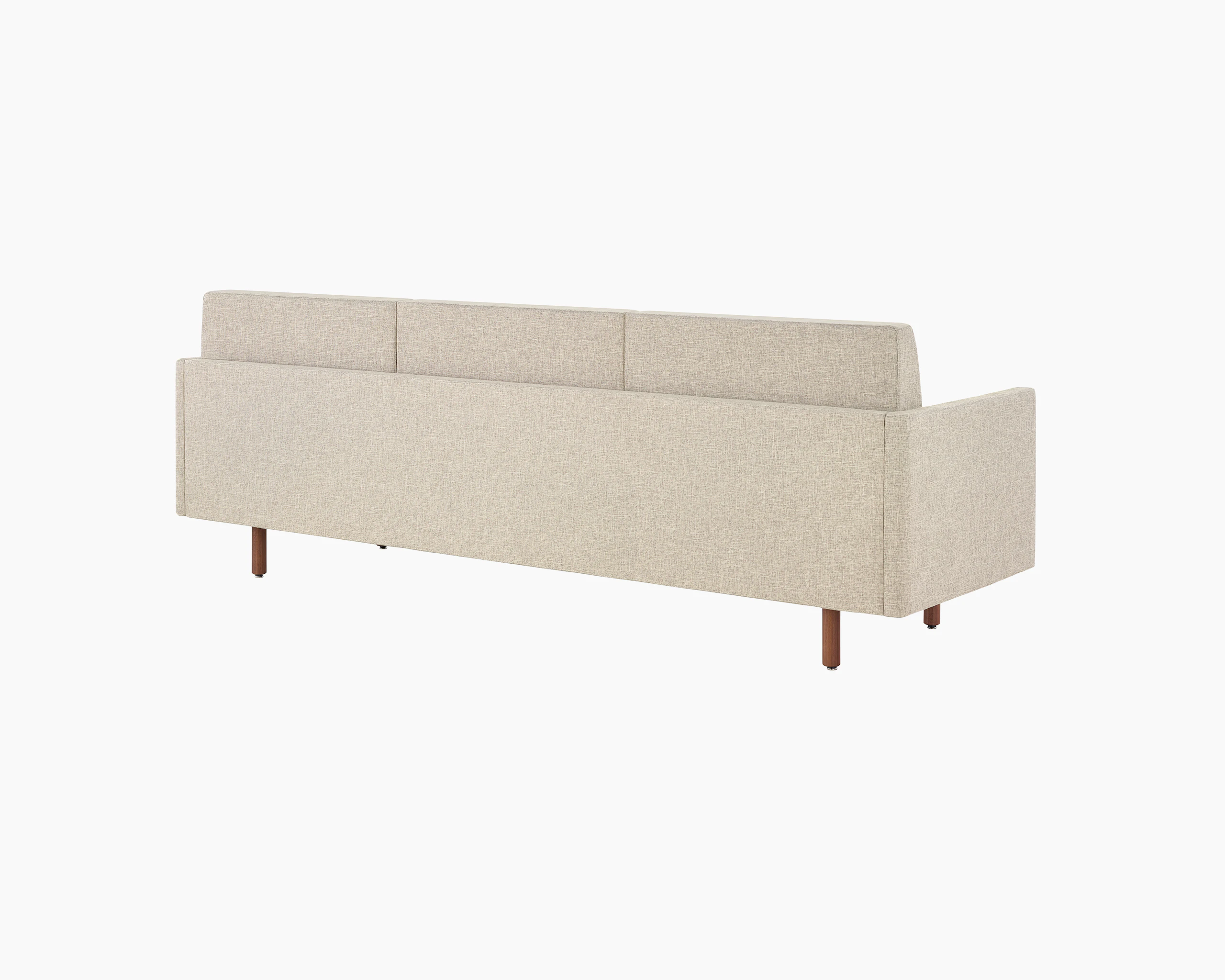 A Tuxedo Classic sofa with bone-colored quilted upholstery, viewed at an angle from behind.