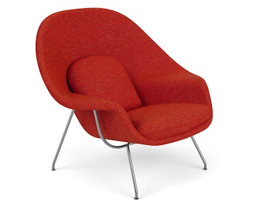 A front three quarter view of a red Womb Chair by Knoll on a white background